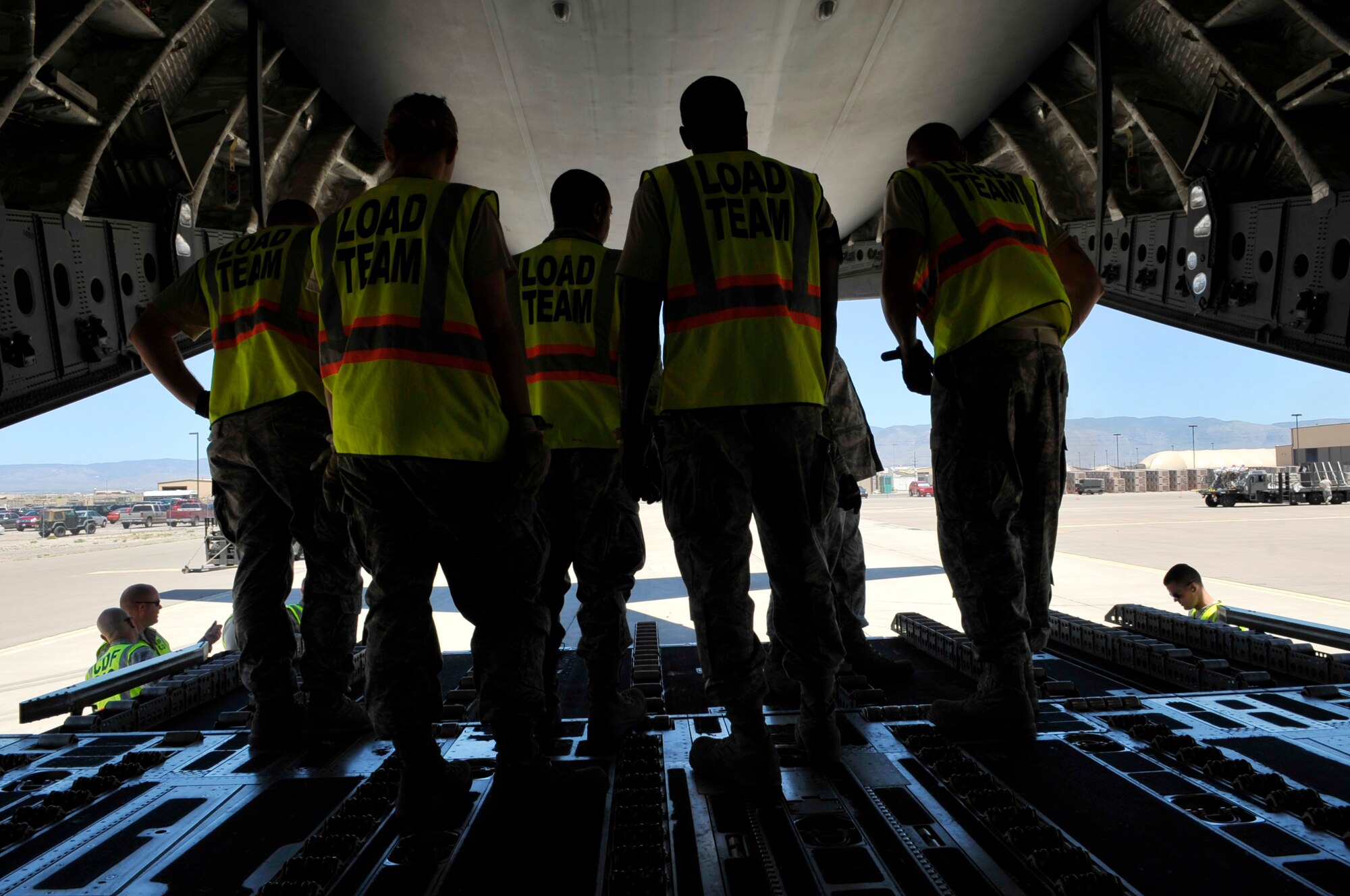 HOLLOMAN AIR FORCE BASE, N.M. -- Airmen from the Cargo Deployment Function load team, 49th Logistics Readiness Squadron, wait on a C-17 Globemaster, for more cargo to arrive May 19, 2010. This is the first of several airlift missions taking 49th Fighter Wing assets to Kadena AB, Japan, in support of a U.S. Pacific Command Theater Security Package. ( U.S. Air Force photo by Airman 1st Class Joshua Turner / Released)
