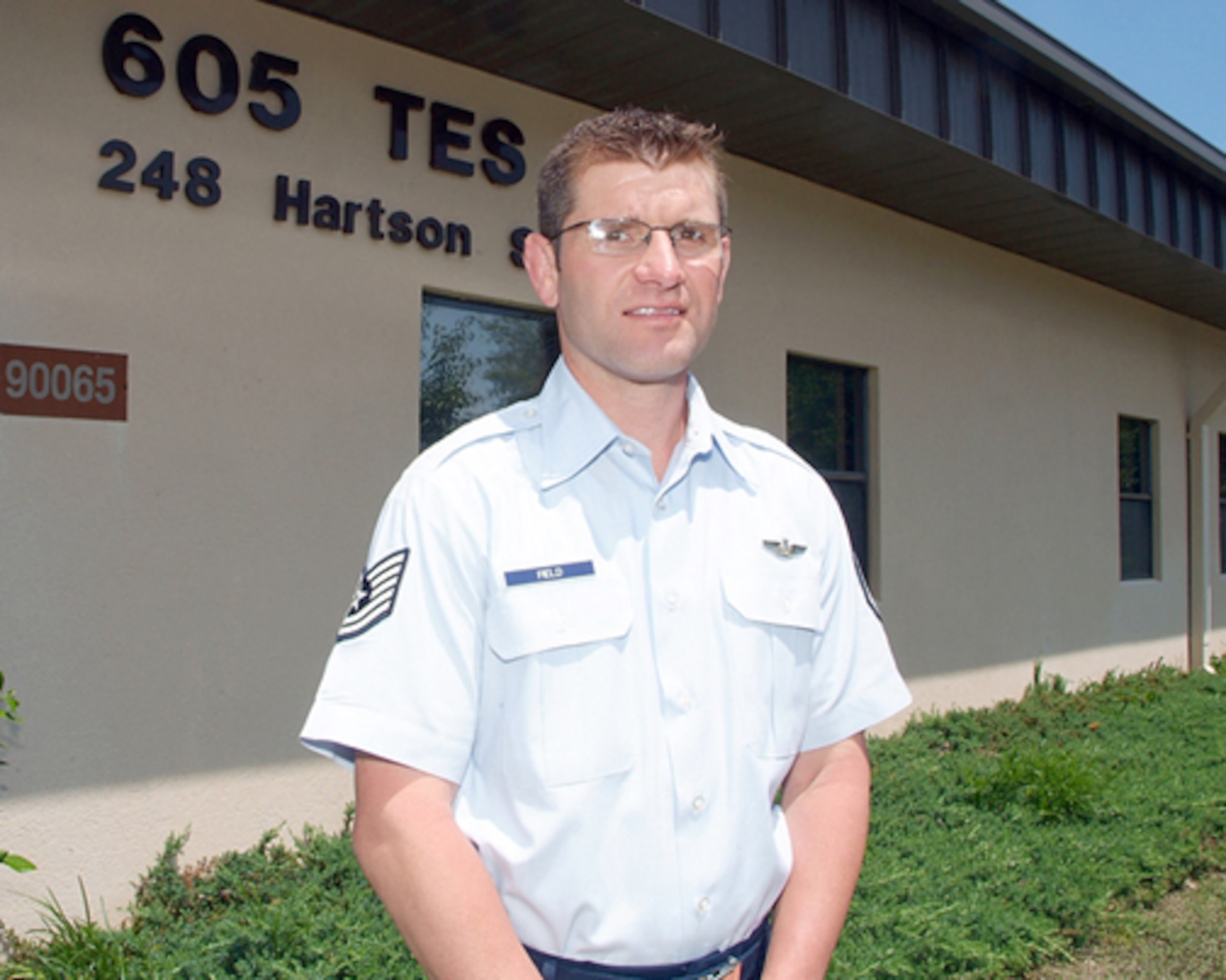 Tech. Sgt. Jay Field poses for a photo in front of the 605th Test and Evaluation Squadron building May 17, 2010 at Hurlburt Field, Fla. Sergeant Field, an Air Force wrestling team coach, saved the Air Force team from forfeiting all points in the team standings by taking the place of an absent Air Force wrestler in the Armed Forces Championship in Colorado. (U.S Air Force photo/Keith Keel)