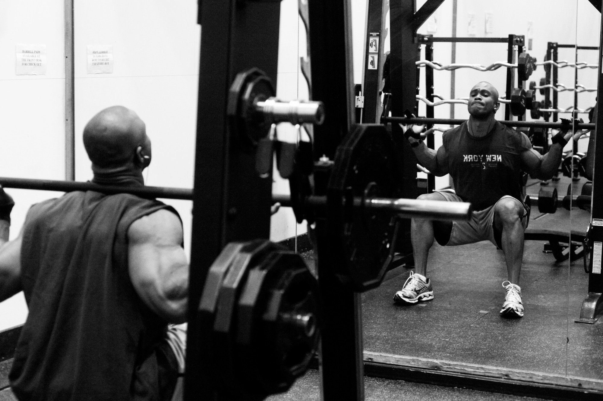 Tech. Sgt. Llewyn McFarlane, 62nd Communications Squadron, performs leg squats during a morning workout May 18. (U.S. Air Force photo/Abner Guzman)


