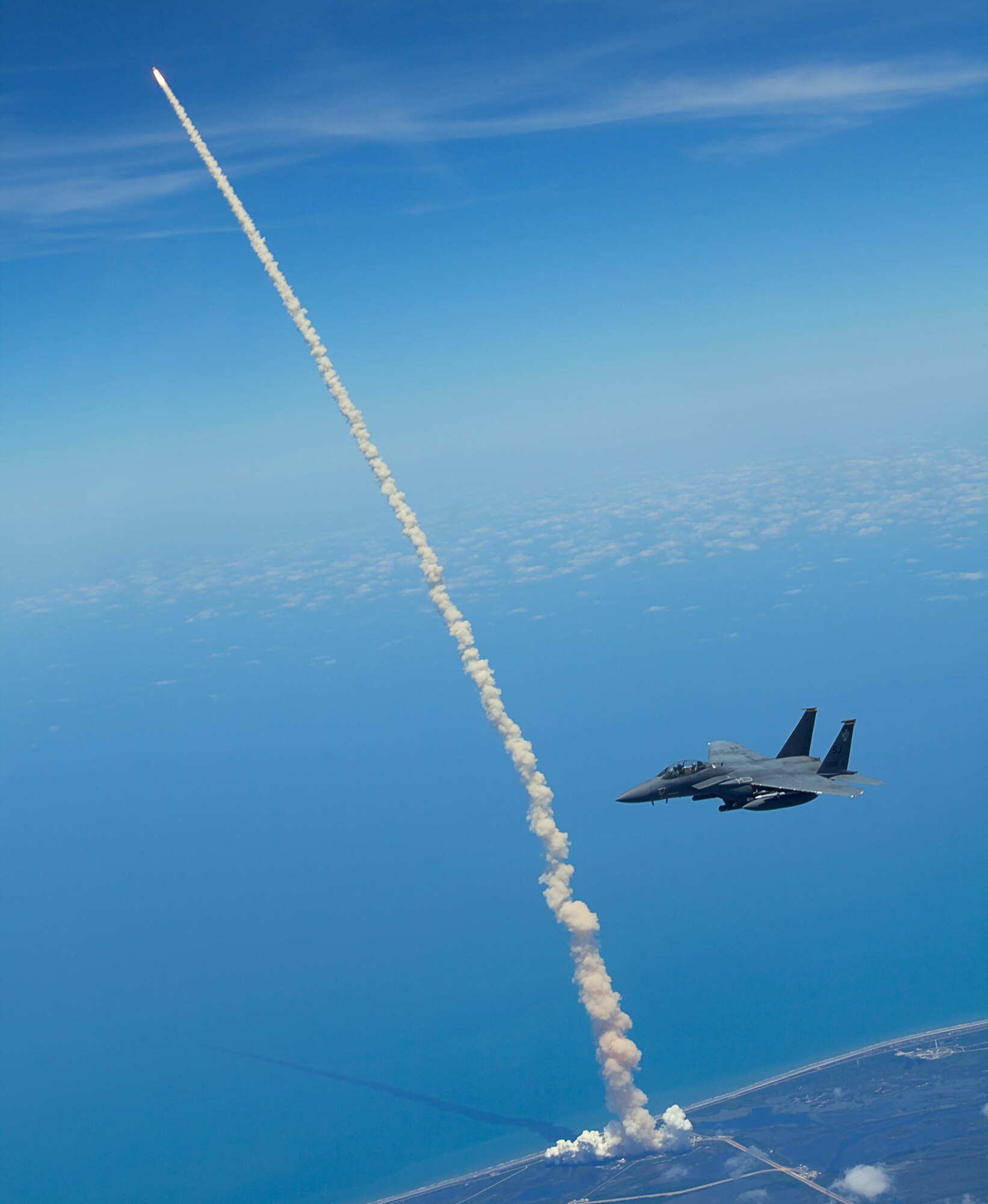 CAPE CANAVERAL AIR FORCE STATION, Fla. -- Lt. Col. Gabriel Green and Capt. Zachary Bartoe patrol the skies over Kennedy Space Center, Fla., in an F-15E Strike Eagle as the Space Shuttle Atlantis launches into space for the last time. During the patrol, Strike Eagle aircrews identified and redirected five aircraft that inadvertently violated the airspace restriction put in place for the launch. Colonel Green is the 333rd Fighter Squadron commander and Captain Bartoe is a 333rd FS weapons system officer. Both aircrew members are assigned to Seymour Johnson Air Force Base, Goldsboro, N.C. (U.S. Air Force photo/Capt. John Peltier)  