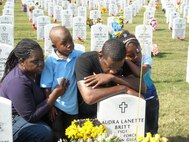 The family of Tech. Sgt. Audra Britt gather around her grave at the Fort Sam Houston National Cemetery. Sergeant Britt was killed by a drunk driver in April 2009. (Courtesy photo)