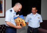 Col. Howard Jones III, commandant of the Defense Language Institute English Language Center, presents Brig. Gen. Jaime Parada, El Salvadoran Vice Chief, Joint General Staff, with a memento during his two-day visit to Lackland. (U.S. Air Force photo/Alan Boedeker)