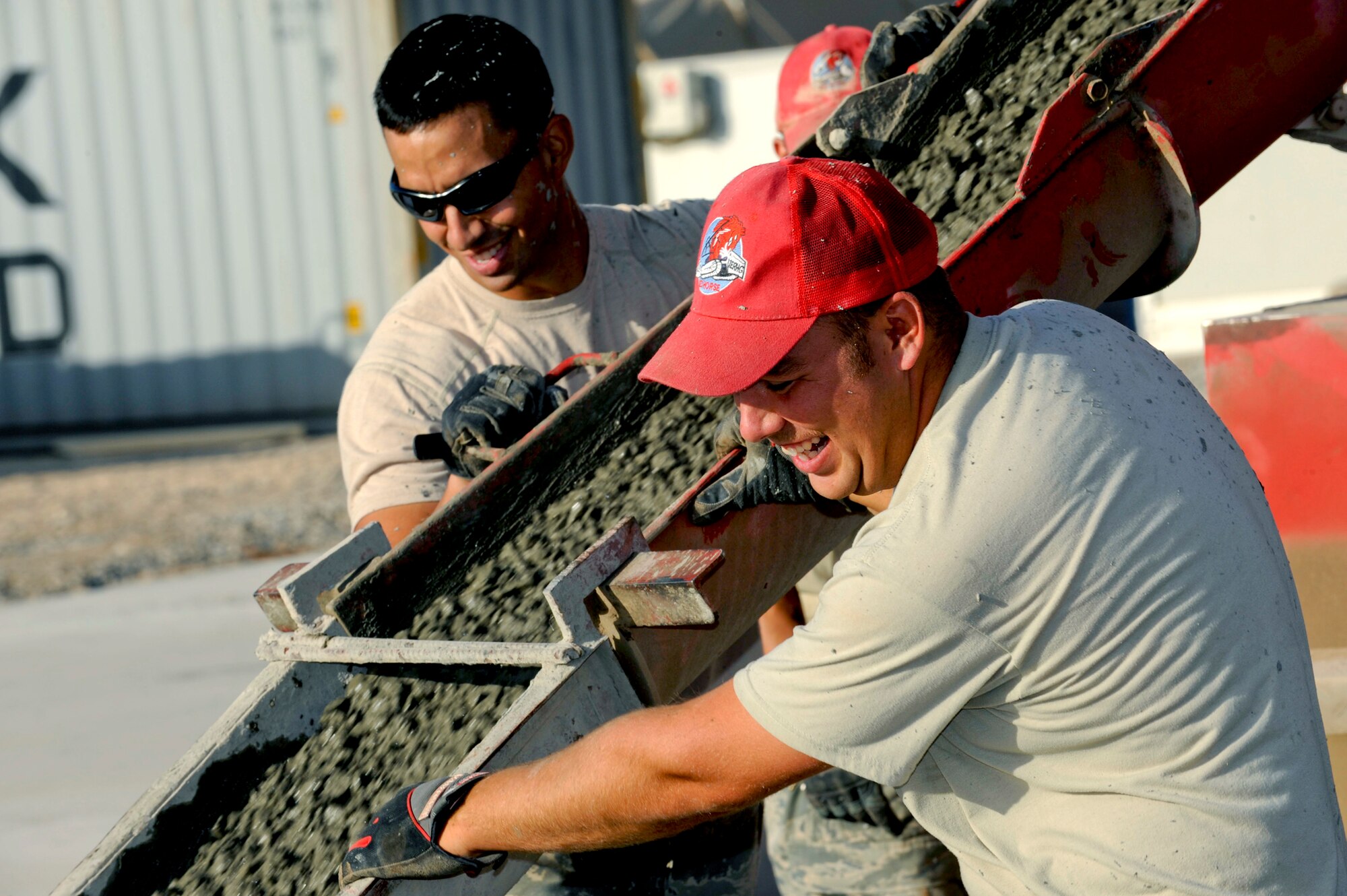 Airmen with the 809th Expeditionary RED HORSE Squadron guide the chute as concrete is poured into the steel forms, creating large-area maintenance shelter pads May 15, 2010, at Kandahar Airfield, Afghanistan.  (U.S. Air Force photo/Senior Airman Nancy Hooks)