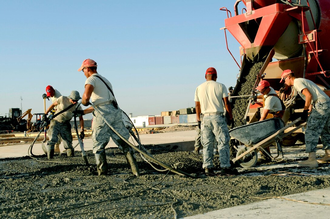 Members of the 809th Expeditionary RED HORSE Squadron pour concrete May 15, 2010, at Kandahar Airfield, Afghanistan for the large-area maintenance shelter pads for aviation maintenance.  (U.S. Air Force photo/Senior Airman Nancy Hooks)