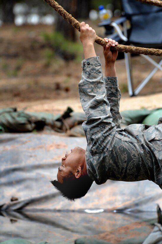 Tech. Sgt. Rochanapan Silpe crosses a water hazard hand over hand on the rope and upside down at the Guardian Challenge 2010's obstacle course May 19 during the final portion of the security forces competition. Sergeant Silpe is a member from the Space and Missile Systems Center's 61st Security Forces Squadron. (Photo by Lou Hernandez)