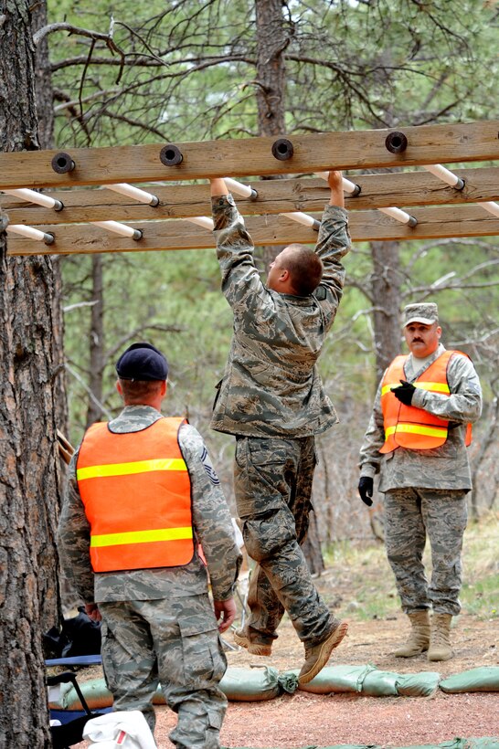 Department of Defense Officer Steven Haymes crosses the monkey bars at the Guardian Challenge 2010's obstacle course May 19 during the final portion of the security forces competition. Officer Haymes is a member from the Space and Missile Systems Center's 61st Security Forces Squadron. (Photo by Lou Hernandez)