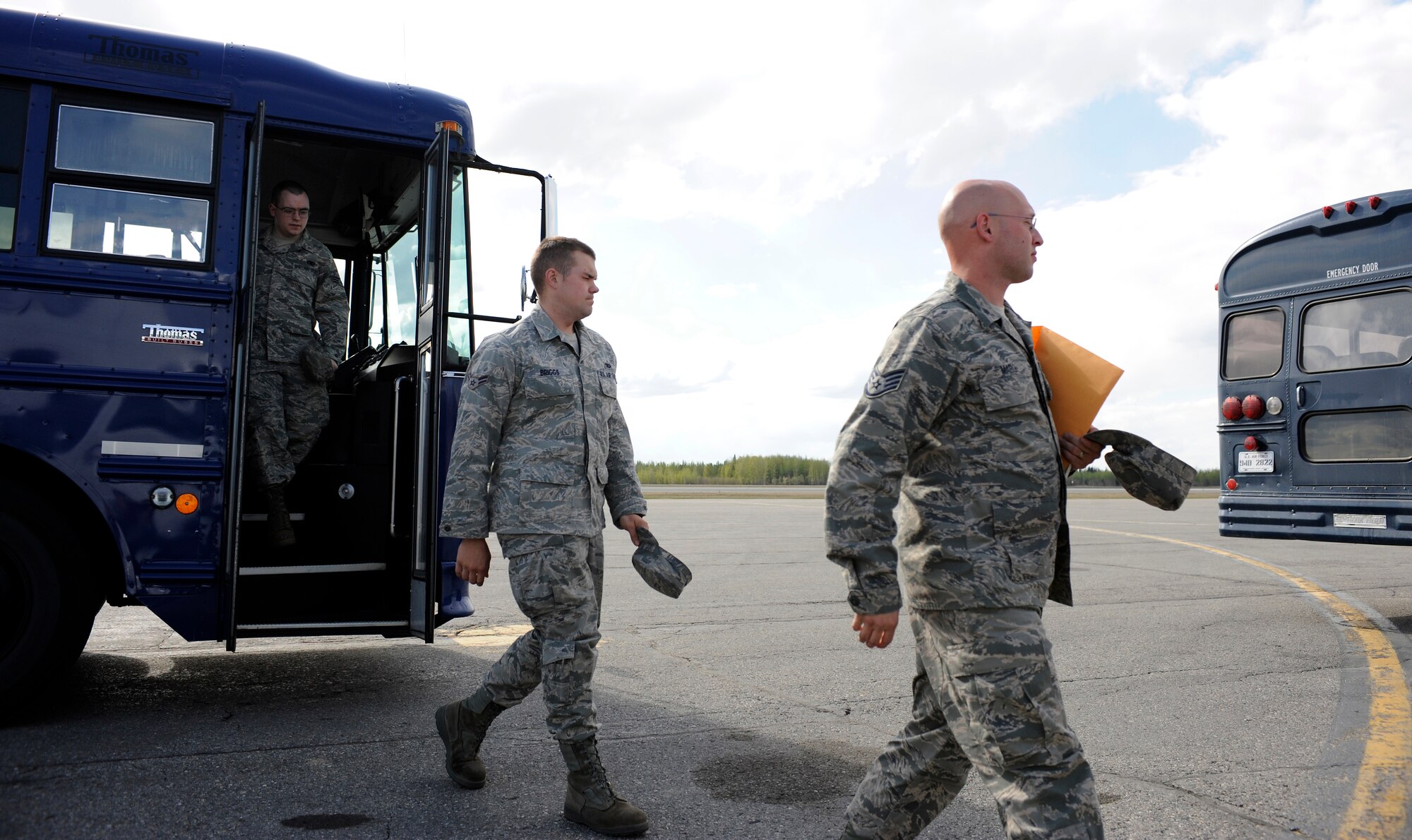 Airmen exit a bus May 18, 2010, Eielson Air Force Base, Alaska. The Airmen are arriving to Eielson Air Force Base to back fill deployed Eielson Airmen. Eielson Air Force Base was simulating deployments and redeployments during the May operational readiness inspection. The Airmen are assigned to the 354th Fighter Wing and 168th Refueling Wing. (U.S. Air Force photo/Airman 1st Class Willard E. Grande II)