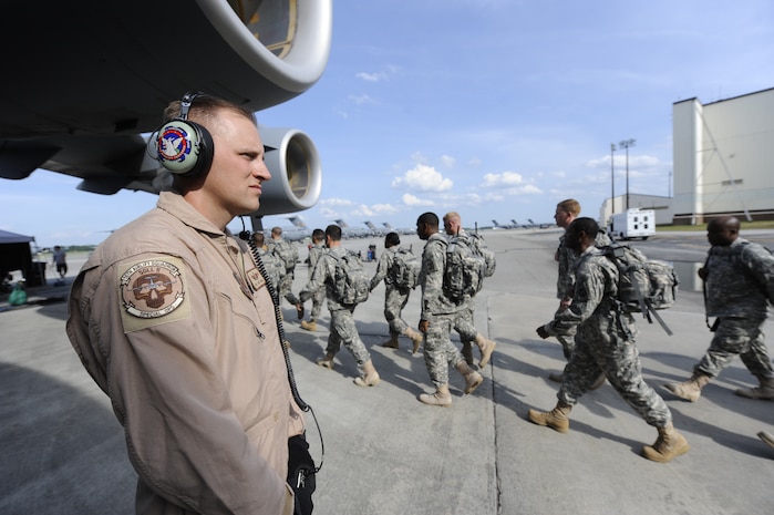 U.S. Air Force Tech. Sgt. Scott Mills stands by as extras in the Lifetime Television show "Army Wives" walk past him to board onto a Charleston C-17 on Joint Base Charleston, S.C., May18, 2010. The series filmed an upcoming episode on Joint Base Charleston which is scheduled to air July 18. Sergeant Mills is a loadmaster with the 16th Airlift Squadron (U.S. Air Force Photo/James M. Bowman)