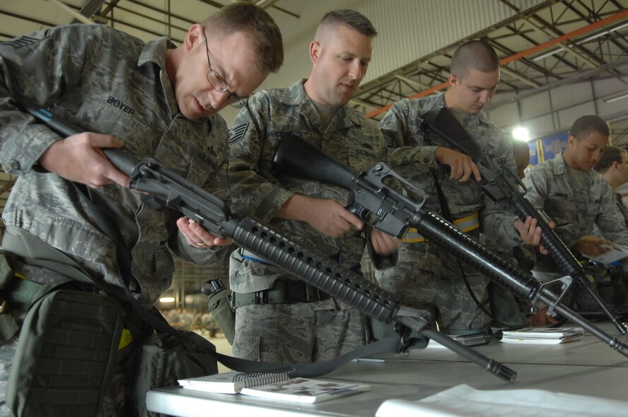 Members of the 86th Airlift Wing clear M-16s during Ability to Survive and Operate training Ramstein Air Base, Germany, May 20. The 86th Airlift Wing Inspections and Readiness flight with the help of augmentees from throughout the base, tested 576 servicemembers in at one of seven stations on M-8/ M-9 chemical detection, self-aid and buddy care and weapons operations procedures in preparation of the upcoming September Operational Readiness Inspection. (U.S. Air Force photo by Tech. Sgt. Michael Voss)