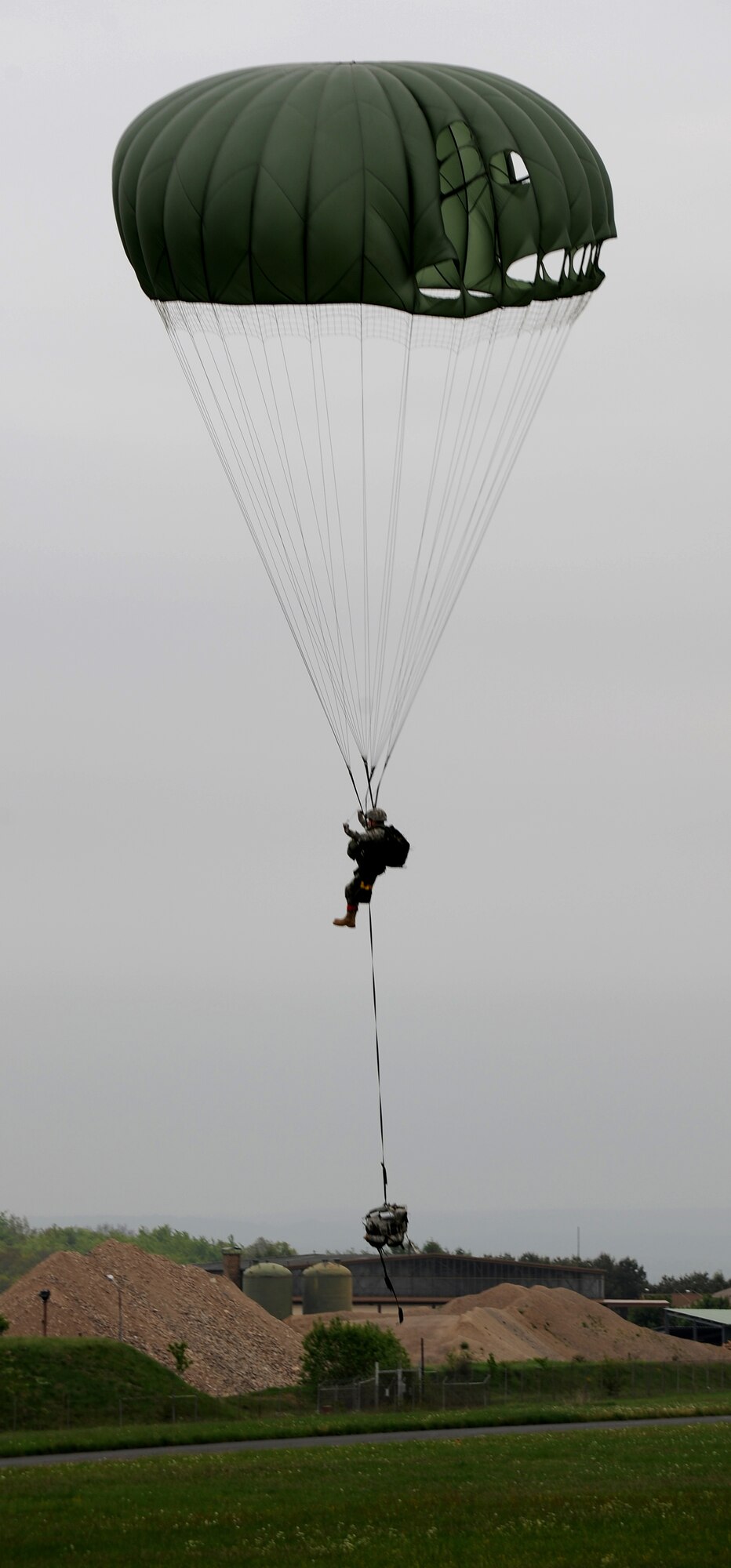 U.S. Air Force Col. Timothy Brown, 435th Contingency Response Group commander, lands after an airborne jump from a C-130J Super Hercules during an Operational Readiness Exercise onto Flugplatz Bitburg, Germany, May 17, 2010. This ORE is the third of five exercises held to prepare Airmen for the Operational Readiness Inspection. After this jump, Col. Brown has successfully conducted 105 static line jumps in his career. The exercise held in Bitburg consisted of over 100 personnel, spanning 30 Air Force Specialty Codes, and three wings. (U.S. Air Force photo by Airman 1st Class Grovert Fuentes-Contreras)