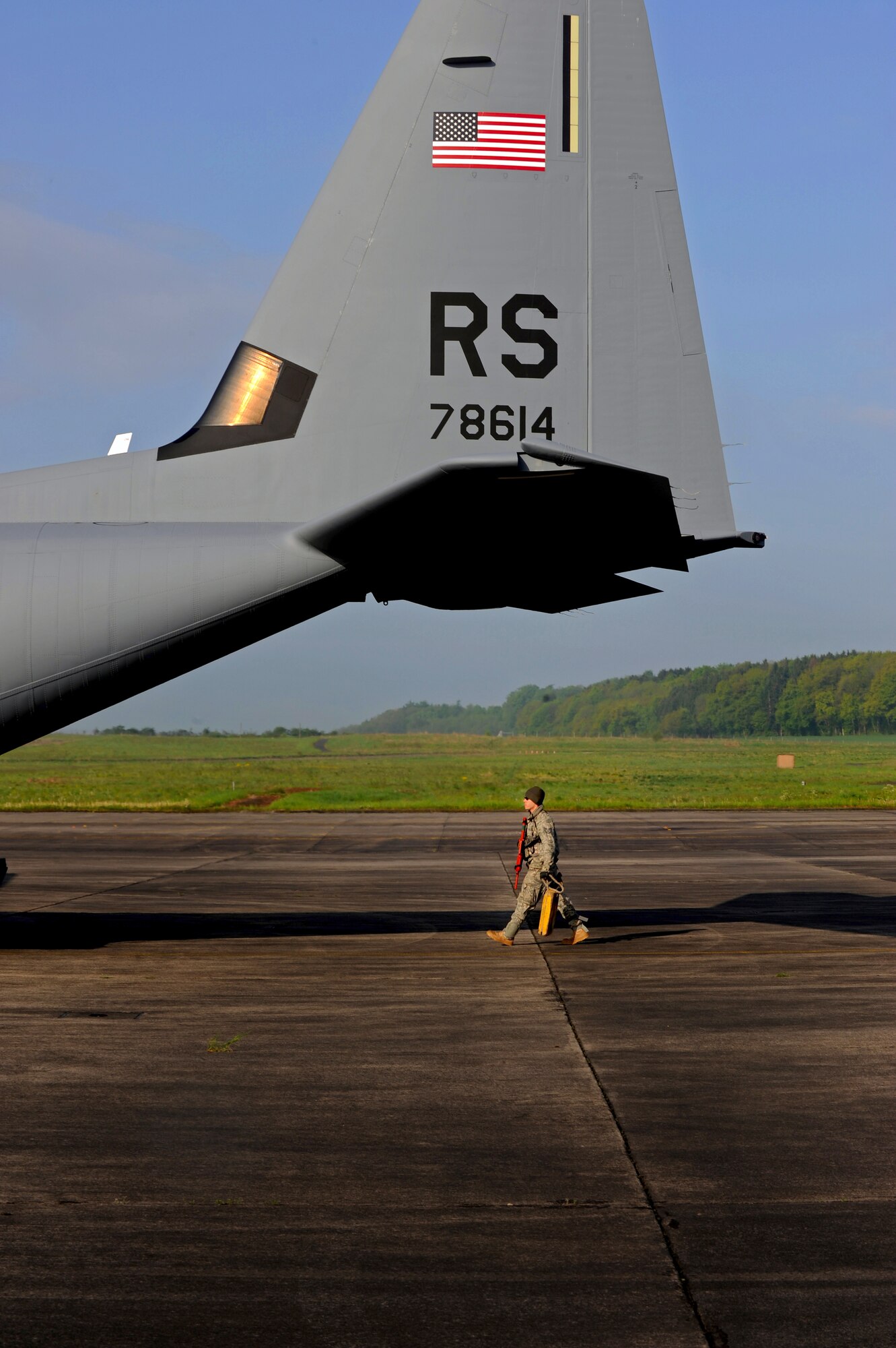 U.S. Air Force Staff Sgt. Justin Gebhardt, 435th Air Ground Operations Wing ramp coordinator, prepares to unload a C-130J Super Hercules during an Operational Readiness Exercise, Flugplatz Bitburg, Germany, May 17, 2010. This ORE is the third of five exercises held to prepare Airmen for an upcoming Operational Readiness Inspection. The exercise held in Bitburg consisted of over 100 personnel, spanning 30 Air Force Specialty Codes and three wings. (U.S. Air Force photo by Airman 1st Class Grovert Fuentes-Contreras)