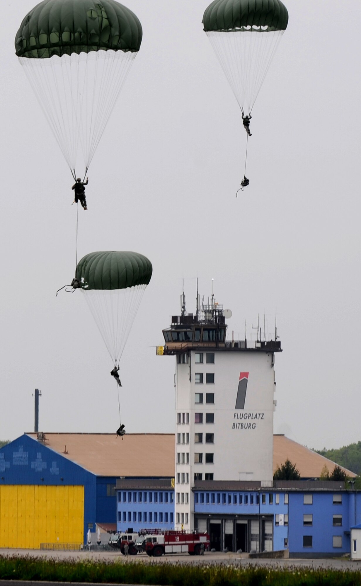 U.S. Air Force Airmen of the 435th Air Ground Operations Wing conduct an airborne jump during an Operational Readiness Exercise, Flugplatz Bitburg, Germany, May 17, 2010. This ORE is the third of five exercises held to prepare Airmen for an upcoming Operational Readiness Inspection. The exercise held in Bitburg consisted of over 100 personnel, spanning 30 Air Force Specialty Codes and three wings. (U.S. Air Force photo by Airman 1st Class Grovert Fuentes-Contreras)