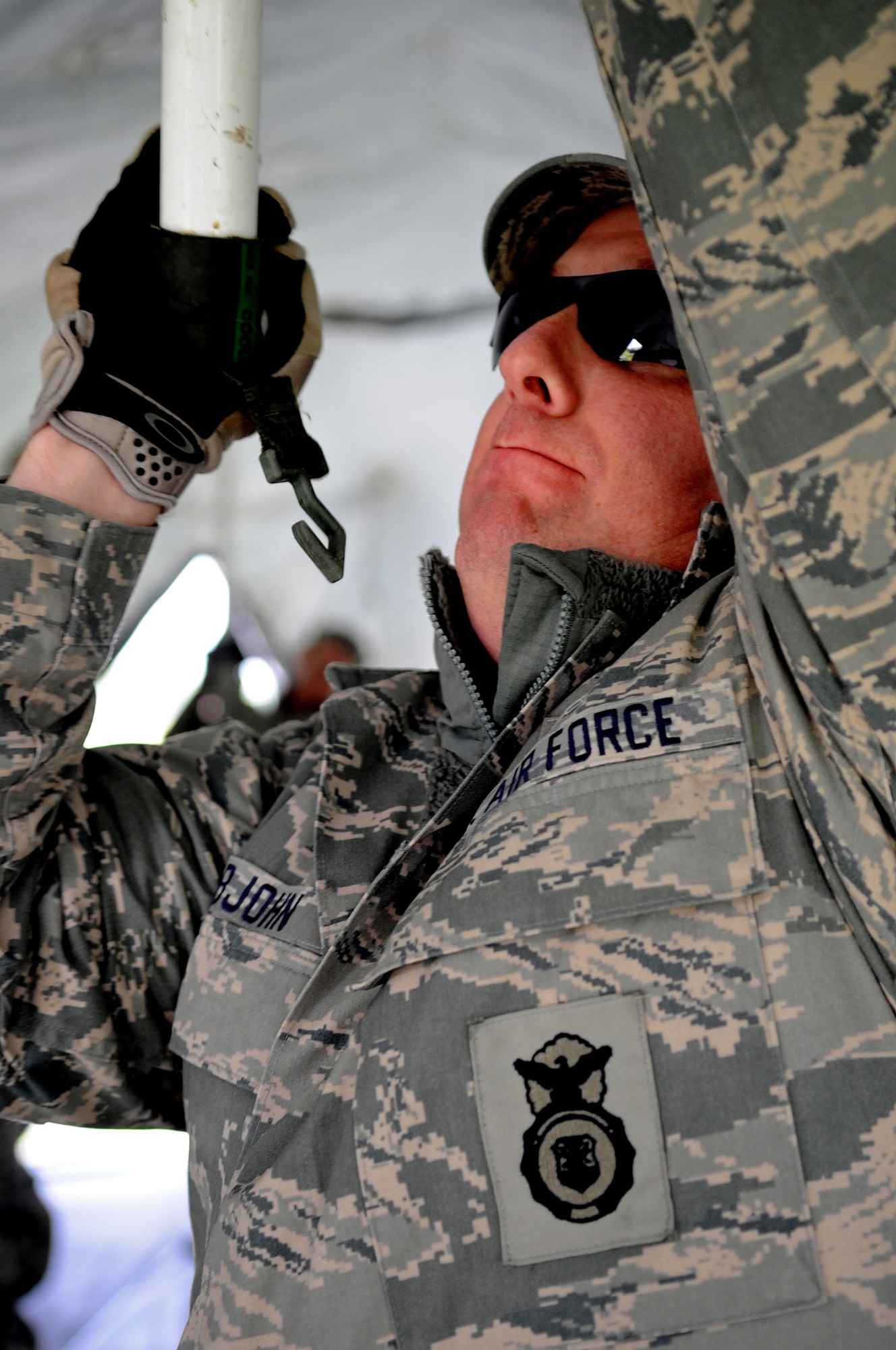U.S. Air Force Master Sgt. Robert Rabjohn, 435th Security Forces Squadron, assists in the construction of sleeping tents during an Operational Readiness Exercise, Flugplatz Bitburg, Germany, May 17, 2010. This ORE is the third of five exercises held to prepare Airmen for an upcoming Operational Readiness Inspection. The exercise held in Bitburg consisted of over 100 personnel, spanning 30 Air Force Specialty Codes and three wings. (U.S. Air Force photo by Airman 1st Class Grovert Fuentes-Contreras)