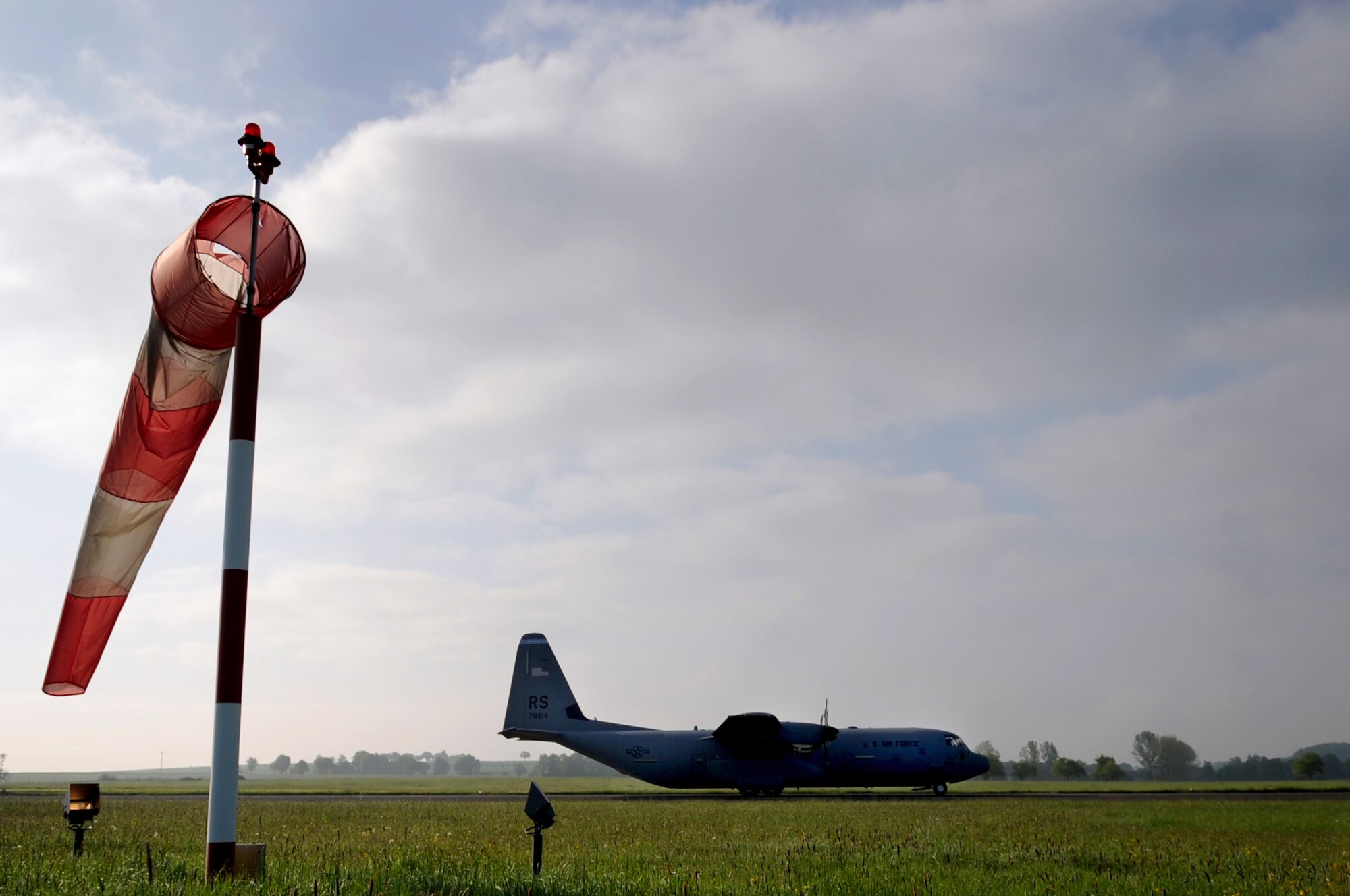 A U.S. Air Force C-130J Super Hercules lands after Airmen with the 435th Air Ground Operations Wing survey and ensure landing capabilities are possible during an Operational Readiness Exercise, Flugplatz Bitburg, Germany, May 17, 2010. This ORE is the third of five exercises held to prepare Airmen for an upcoming Operational Readiness Inspection. The exercise held in Bitburg consisted of over 100 personnel, spanning 30 Air Force Specialty Codes and three wings. (U.S. Air Force photo by Airman 1st Class Grovert Fuentes-Contreras)