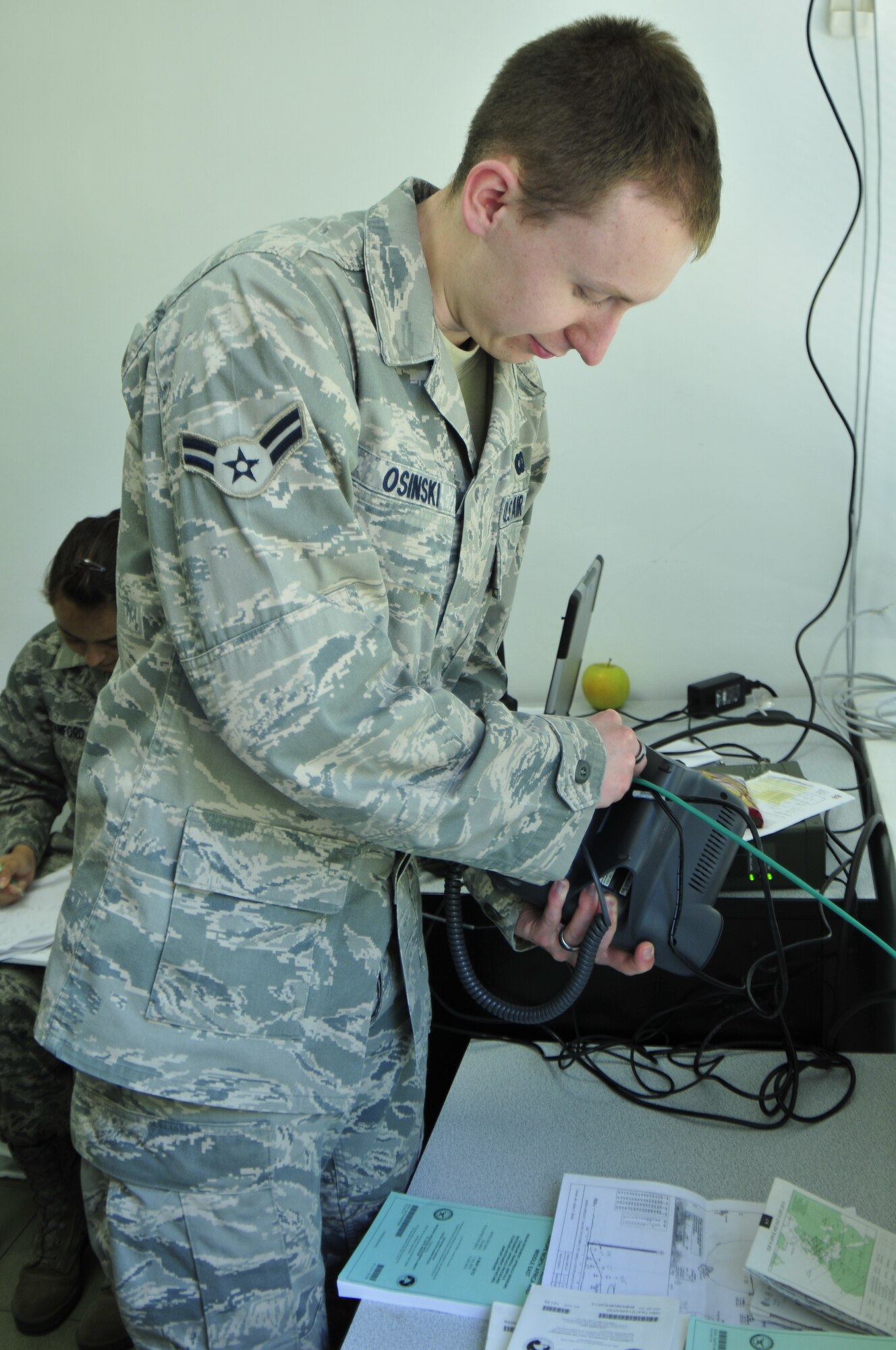 Airman 1st Class Jeremy Osinski, 1st Combat Communications Squadron infrastructure technician, ensures the connectivity of a phone at the operations desk at Graf Ignatievo Air Force Base, Bulgaria. The 1st CBCS is here as part of joint-training exercise Sentry Gold, an exercise designed to assist the Bulgarian air force as it continues its integration into NATO and to build partnerships between the two air forces. (Courtesy photo)