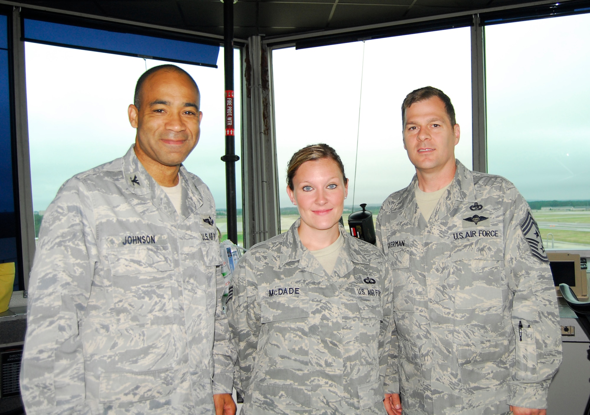 Col. James Johnson, 43rd Airlift Wing Commander, (far left) and Chief Master Sgt. Douglas Ackerman, 43rd AW Command Chief, (far right) presented the Commander’s Coin to Staff Sgt. Shantell McDade, 43rd Operations Support Squadron, May 18.  Sergeant McDade is an Air Traffic Control Watch Supervisor for Pope tower operations. (U.S. Photo/2nd Lt. Cammie Quinn)