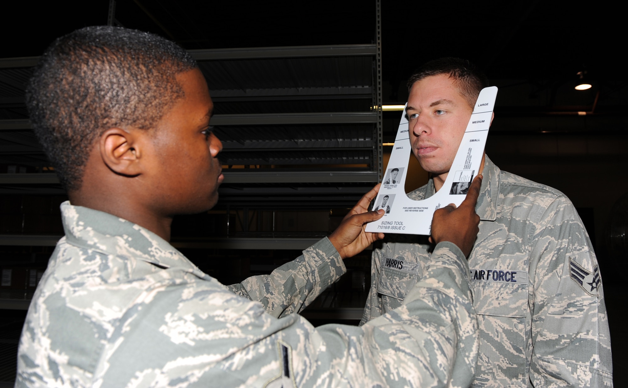 SEYMOUR JOHNSON AIR FORCE BASE, N.C. -- Airman Arnett Dickson determines a mask size for Senior Airman Ashley Harris here May 19, 2010. The new mask has better breathing capabilities and is made from a softer material. Airman Dickson, 567th RED HORSE Squadron supply troop, hails from Cleveland. Airman Harris, 4th Logistics Readiness Squadron vehicle operator, is a native of Jacksonville. (U.S. Air Force photo/Senior Airman Gino Reyes)