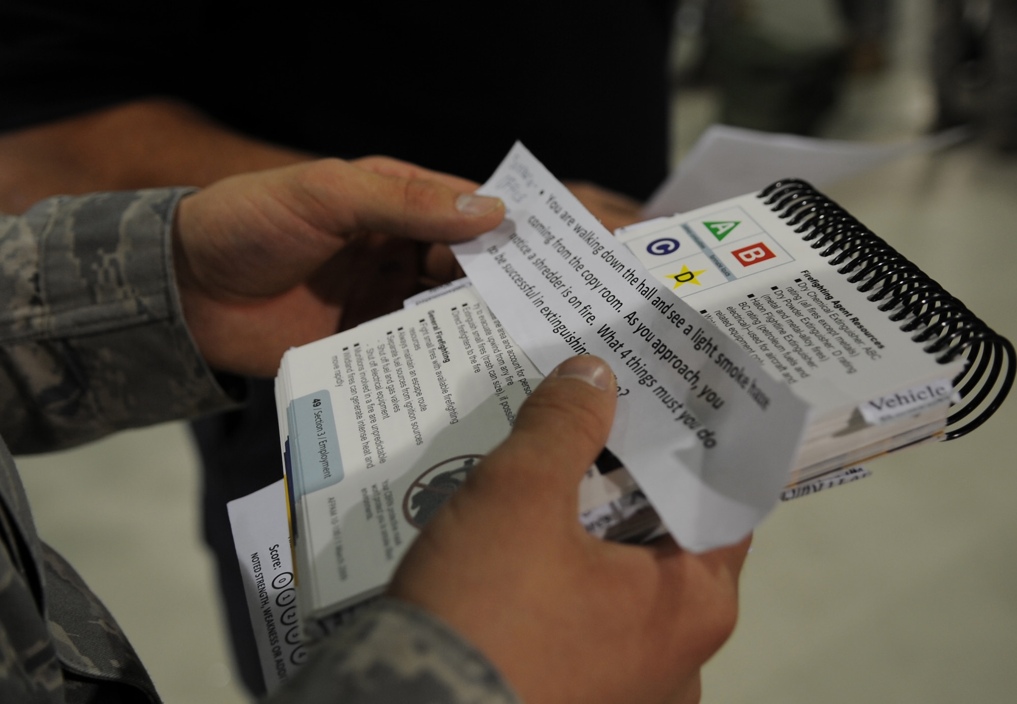 An Airman reads a fire extinguisher test scenario card during an Ability to Survive and Operate (ATSO) exercise, Ramstein Air Base, Germany, May 20, 2010. The wing conducts exercises to evaluate its mission readiness and ability to survive and operate in a chemical environment. (U.S. Air Force photo by Airman 1st Class Caleb Pierce)