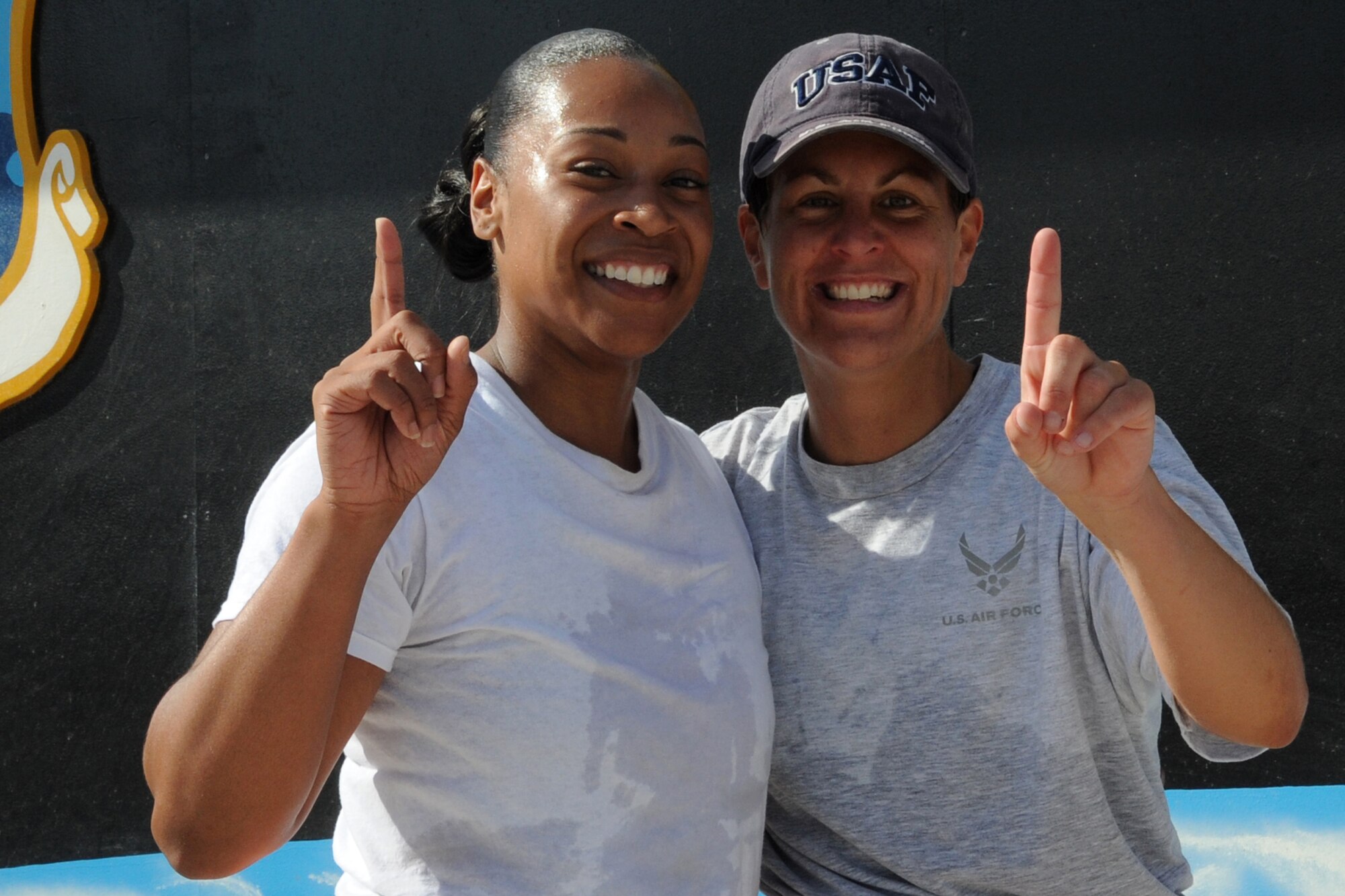 Ms. Tiffany Foster and Maj. Maggie Howard, both 380th Air Expeditionary Wing members, celebrate after they win the 380th Amazing Race at an undisclosed location in Southwest Asia on May 8, 2010.  Members from across the base competed in various events to win donated prizes. The 380th AEW supports Operations Iraqi Freedom and Enduring Freedom and the Combined Joint Task Force-Horn of Africa. Its comprised of four groups and 12 squadrons and the wing's deployed mission includes air refueling, surveillance and reconnaissance in support of overseas contingency operations in Southwest Asia.(U.S. Air Force photo/Senior Airman Jenifer H. Calhoun/Released)