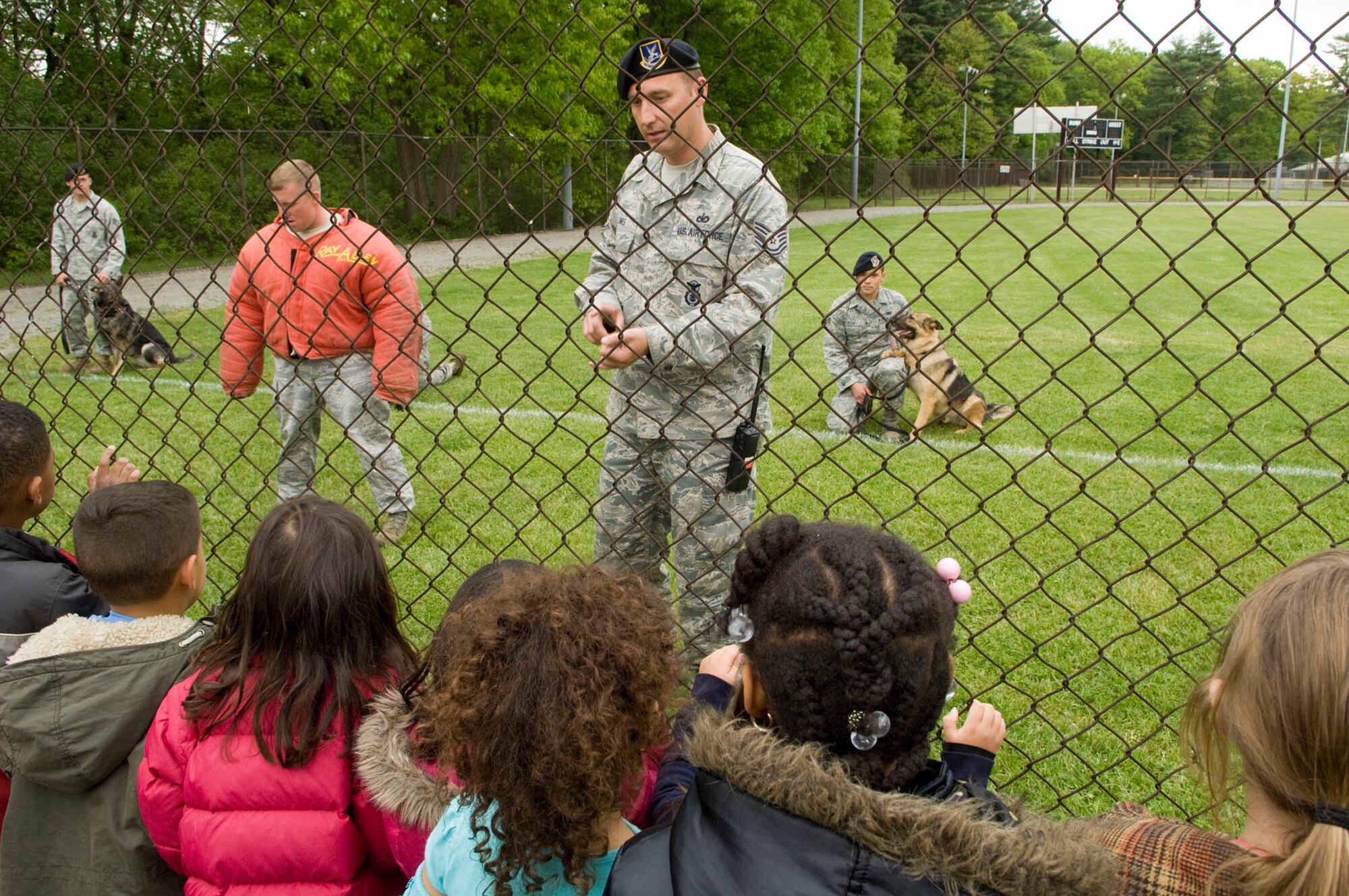 HANSCOM AIR FORCE BASE, Mass. – As part of Exhibition Day for Police Week, Tech. Sgt. Andrew Limes (center), from the 66th Security Forces Squadron, Military Working Dog Handler Section, discusses with children from the School Age Program about military working dogs. The Security Forces Squadron had many items and equipment on display on May 12 for Exhibition Day as part of Police Week activities. (U.S. Air Force photo by Mark Wyatt)