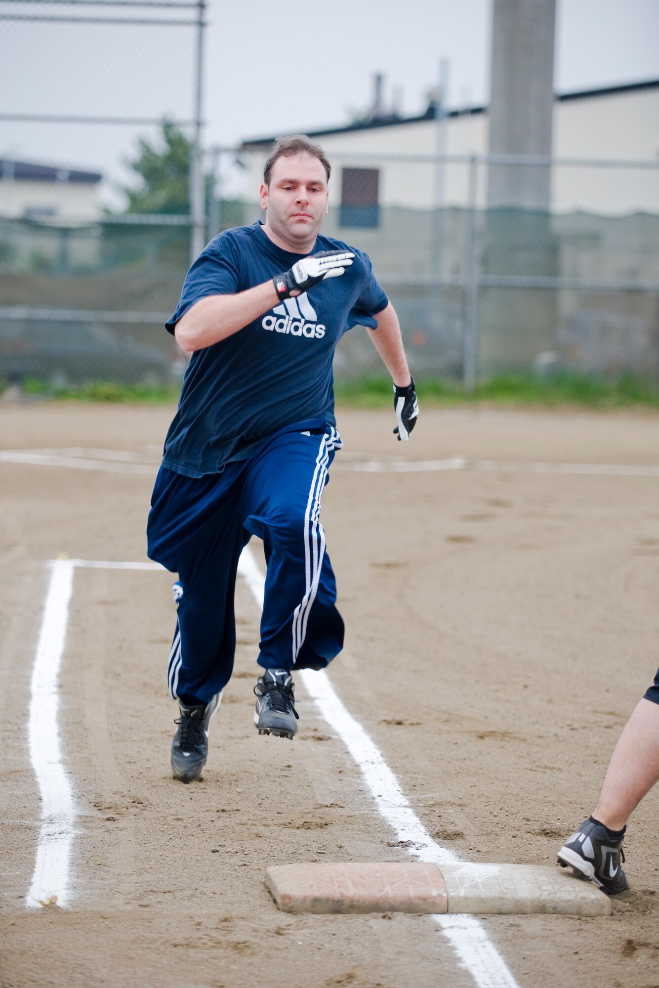 MISAWA AIR BASE, Japan -- Petty Officer 1st Class Justin Joseph, of the Navy Information Operations Command, sprints to first base during an intramural softball game against the Misawa Security Operations Center May 18, 2010. The game was the first of the season for the two teams. (U.S. Air Force photo/Senior Airman Jamal D. Sutter)