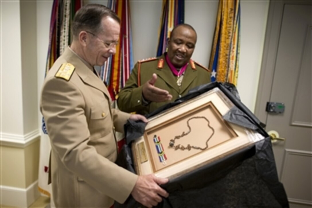 South African Gen. Godfrey Nhlanhla Ngwenya, chief of the National Defense Force, presents U.S. Navy Adm. Mike Mullen, chairman of the Joint Chiefs of Staff, with a thank-you gift from his homeland at the Pentagon, May 20, 2010. 