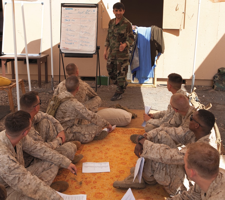 Marines with 2nd Battalion, 3rd Marines, Company F, 2nd platoon, listen intently as Mustafa Amanyar, interpreter and foreign language specialist, Defense Training Systems, and a native of north Kabul, Afghanistan, teaches them how to say thank you in Pashto during a Cultural Lane class at Marine Corps Training Area Bellows May 20. The class was part of a weeklong training evolution preparing the 2/3 Marines for their upcoming Operation Enduring Freedom deployment in winter 2010.