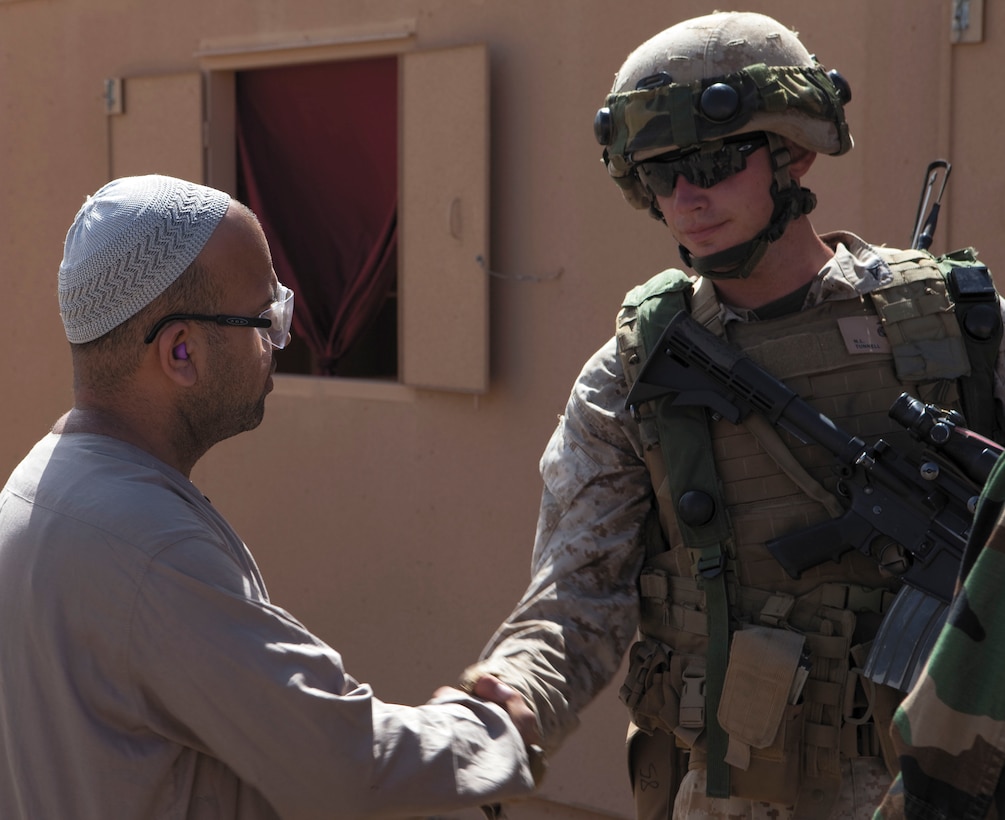 Lance Cpl. Nicholas Tunnell, squad leader, 2nd squad, 2nd platoon, Company F, 2nd Battalion, 3rd Marines, and a native of Phoenix, establishes a rapport with an Afghan local national on a patrol at Marine Corps Training Area Bellows May 20. The patrol was part of predeployment training in preparation for 2/3’s upcoming Operation Enduring Freedom deployment in winter 2010.