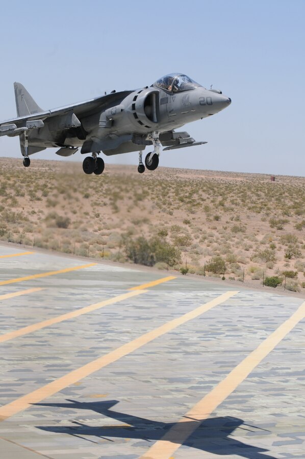 Capt. Luke Jacobs, Marine Attack Squadron 513 pilot, vertically lands an AV-8B Harrier at Auxiliary Airfield 2 on the Barry M. Goldwater Range in Arizona May 20, 2010. The Nightmares used the airfield, which simulates a ship’s landing deck, to get their aircraft carrier landing qualification before their support of Exercise Dawn Blitz aboard the USS Bonhomme Richard May 24-28, 2010. The exercise is held to provide a training scenario that includes naval, aviation and ground elements all at once. While participating in the exercise, the Nightmares will provide close-air support for the 1st Marine Expeditionary Force.