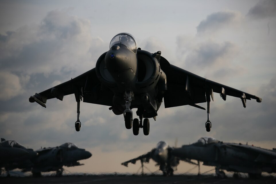 Lt. Col. Terence J. Dunne, a pilot and readiness officer with Marine Aircraft Group 14, lands an AV-8B Harrier onto the HMS Ark Royal, the British Royal Navy’s flagship aircraft carrier, May 21.  ::r::::n::“The ship presented pilots a rare challenge of taking off from the its 12-degree ramped deck,” said Dunne.