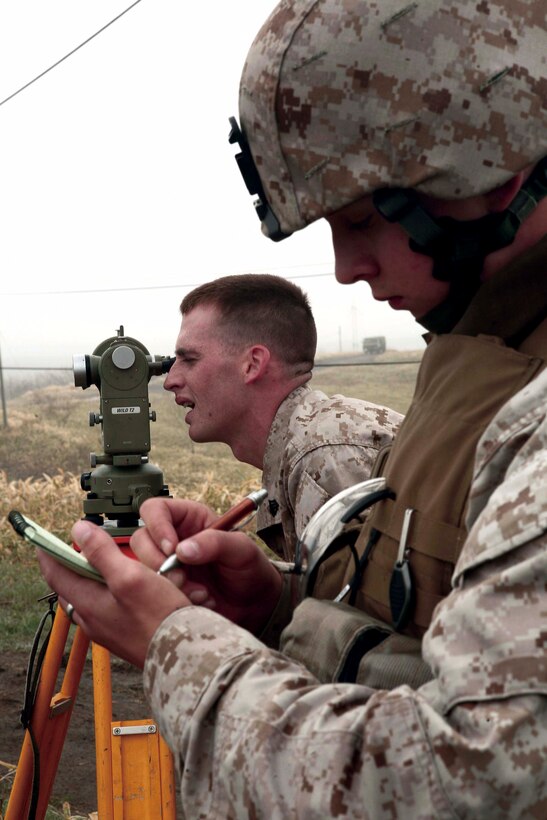 Lance Cpl. Larry Keyes, right, writes down information as Sgt. Chris McGowan verifies their position with a T2E Theodolite. Keyes and McGowan are fire direction controlman with 3rd Battalion, 12th Marine Regiment, 3rd Marine Division, III Marine Expeditionary Force.