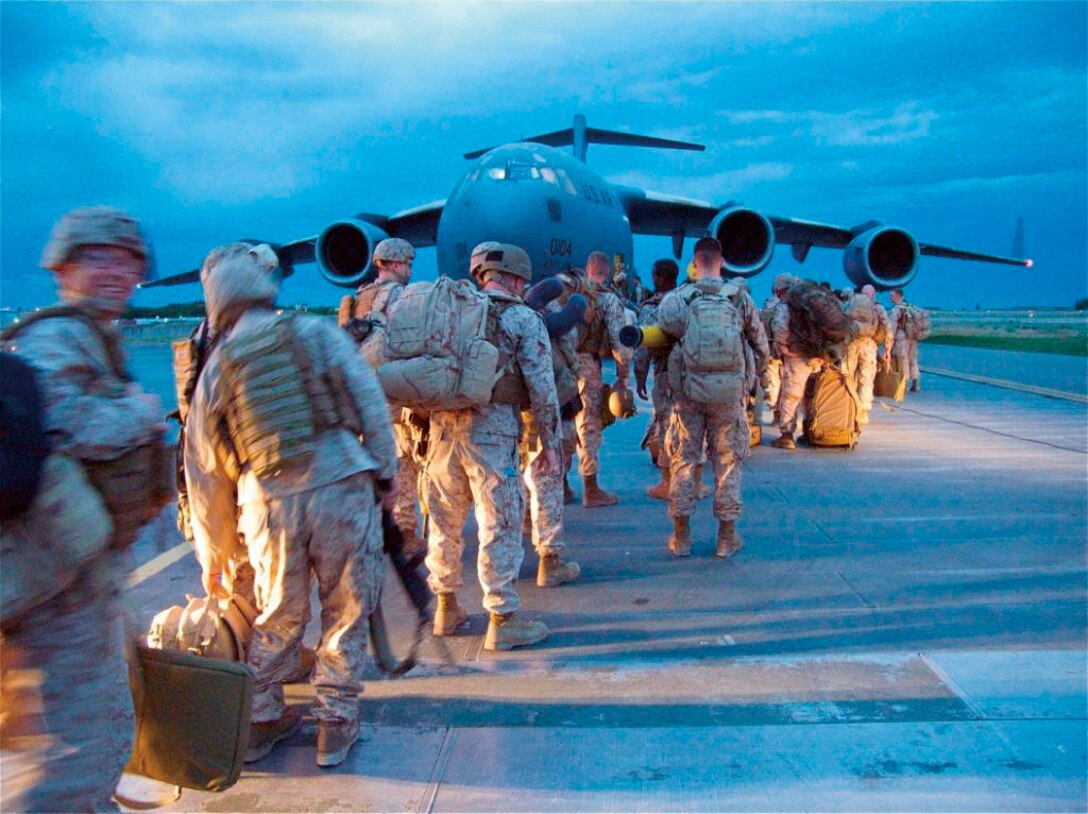 Marines and sailors of 5th Air Naval Gunfire Liaison Company, III Marine Expeditionary Force Headquarters Group, III MEF, board a C-17 in Manas, Kyrgyzstan, May 21, headed for Camp Leatherneck, Helmand province, Afghanistan. 5th ANGLICO began its seven-month deployment in May to provide the MAGTF commander a liaison capability to plan, coordinate, and conduct terminal control of fires in support of joint, allied and coalition forces.
