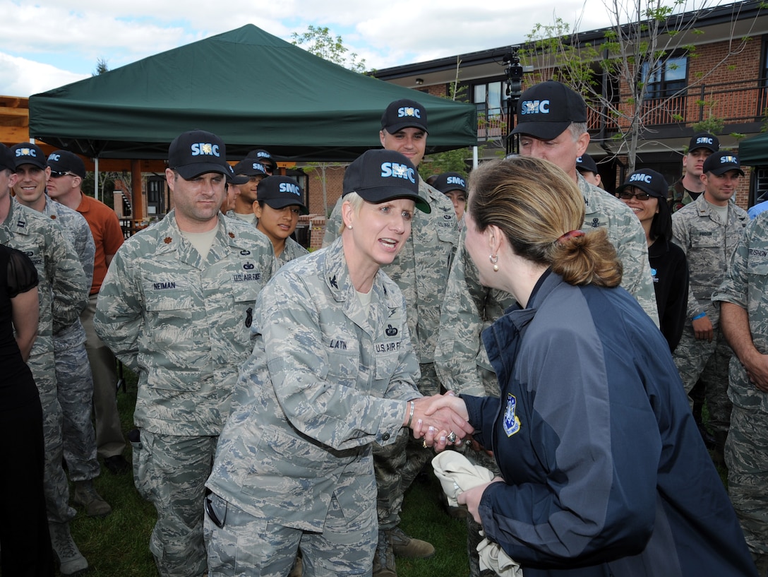 Col. Anita Latin (left), 61st Air Base Wing commander, greets Ms. Erin Conaton, Under Secretary of the Air Force, upon her arrival at Air Force Space Command at Peterson Air Force Base, Colo., to attend Guardian Challenge 2010 festivities. (Photo by Lou Hernandez)