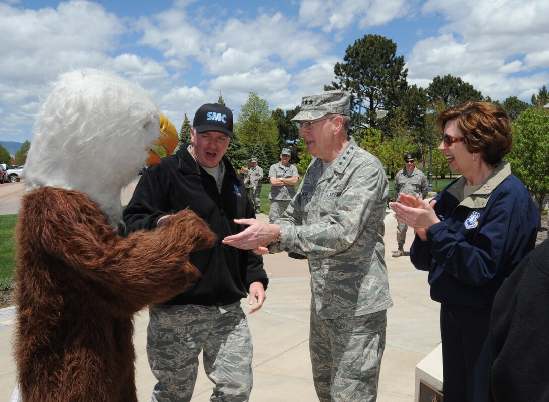 Chief Master Sgt. Mark Repp (middle), Space and Missile Systems Center command chief, introduces The Eagle, SMC mascot, to Gen. C. Robert Kehler (right), Commander of Air Force Space Command at the Guardian Challenge 2010 Arrival Ceremony May 20. General Kehler is joined by Marj Kehler. (Photo by Lou Hernandez)