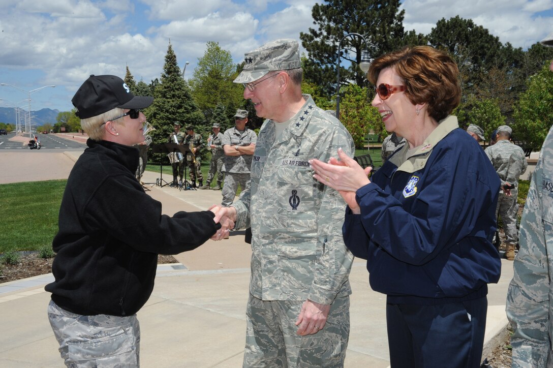 Gen. C. Robert Kehler (middle), Commander of Air Force Space Command, greets Col. Anita Latin (left), Commander of the 61st Air Base Wing at Los Angeles Air Force Base during the Guardian Challenge 2010 Arrival Ceremony May 20 at Peterson AFB, Colo. General Kehler is joined by Marj Kehler (right). (Photo by Lou Hernandez)