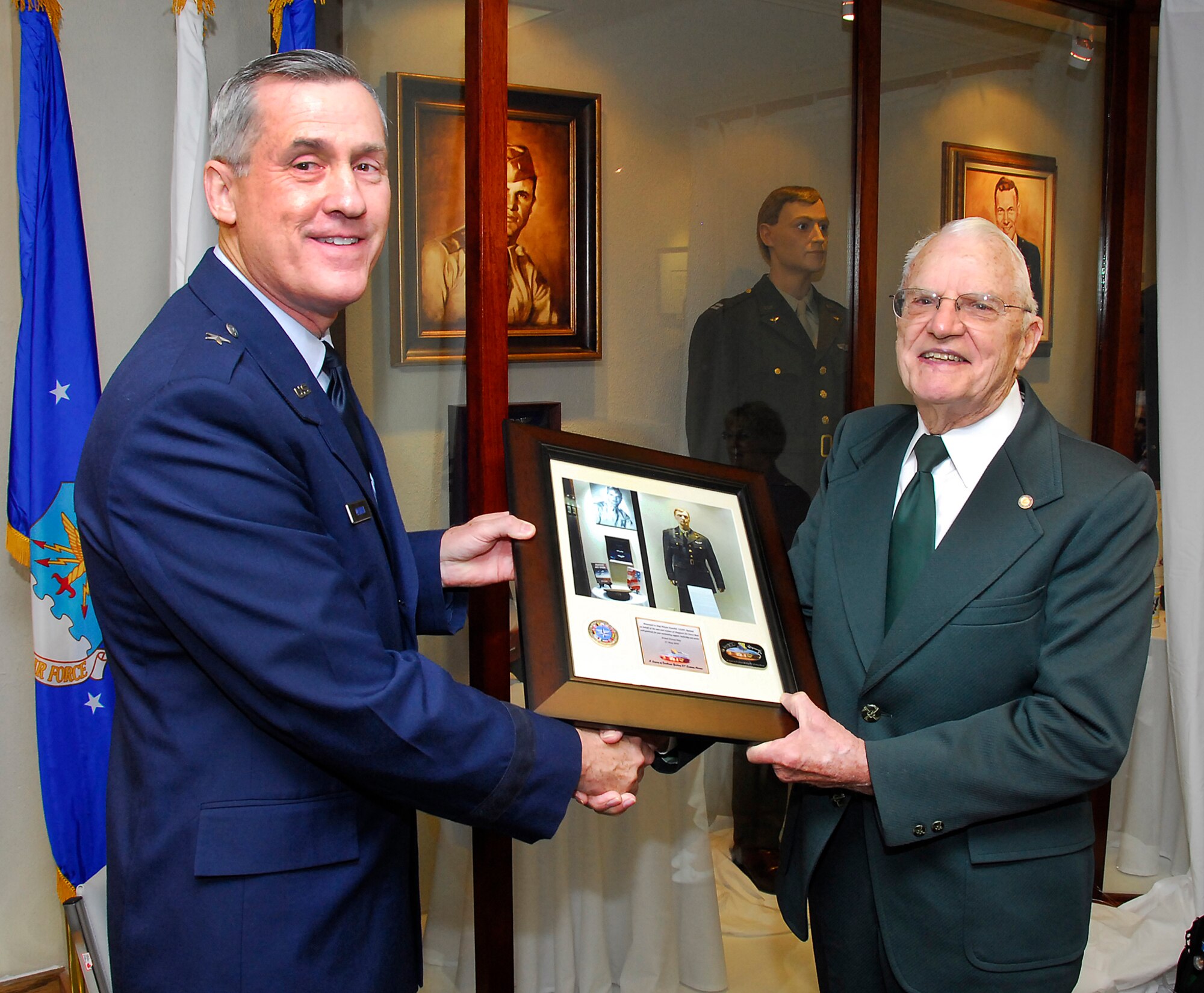82nd Training Wing Commander Brig. Gen. O.G. Mannon presents a Sheppard photo memento plaque to retired Maj. Wayne Kuschel, a Sheppard Hall of Heroes honoree, during the Sheppard Hall of Heroes ceremony at the Heritage Center at Sheppard Air Force Base, Texas, May 21, 2010. Three Airmen were honored at the ceremony for their service which spanned conflicts from World War II to Desert Storm. (U.S. Air Force photo/Harry Tonemah)