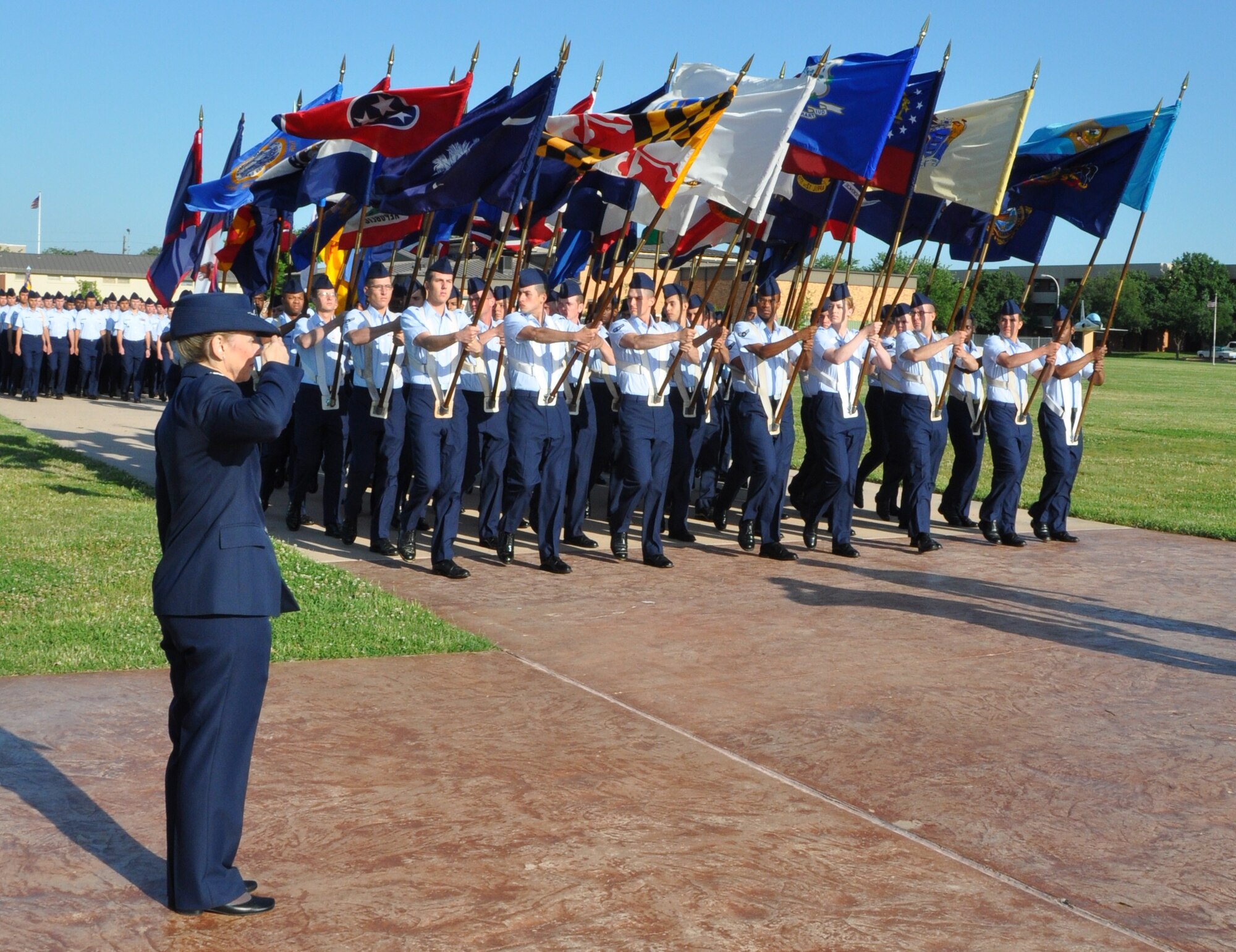 During the Armed Forces Day Parade, Col. Marcia Rossi, the reviewing official, salutes as the colors pass in review May 21, 2010. Prior to the Pass in Review, a retirement ceremony was held for Colonel Rossi, who served more than 30 years in the Air Force. (U.S. Air Force Photo/Airman 1st Class Adawn Kelsey)
