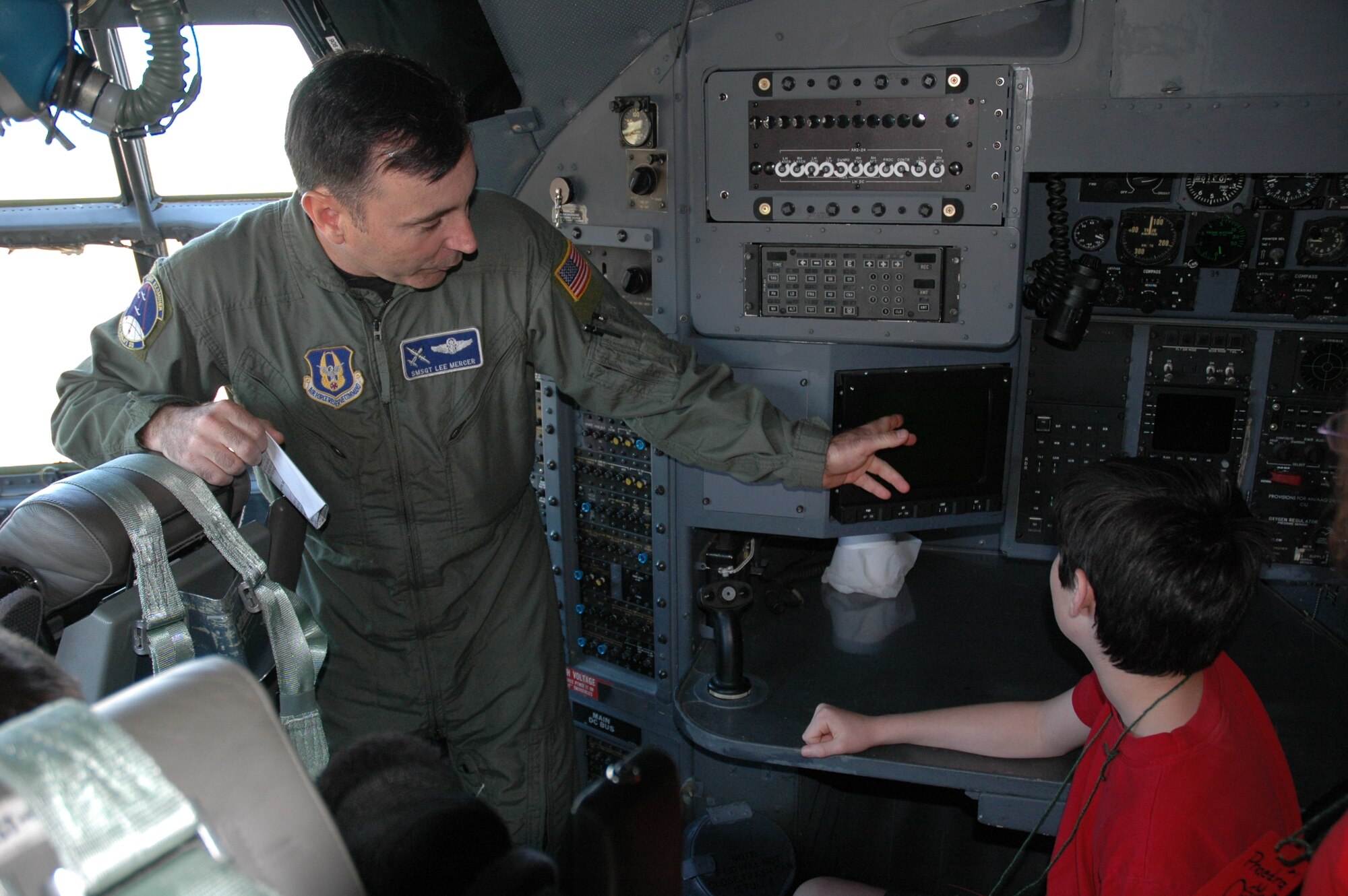 Senior Master Sgt. Lee Mercer explains the navigator's station to Flowers Elementary School student Justin Mason during Aerospace Adventures Day at Maxwell Air Force Base. (Air Force phot/Gene H. Hughes)
