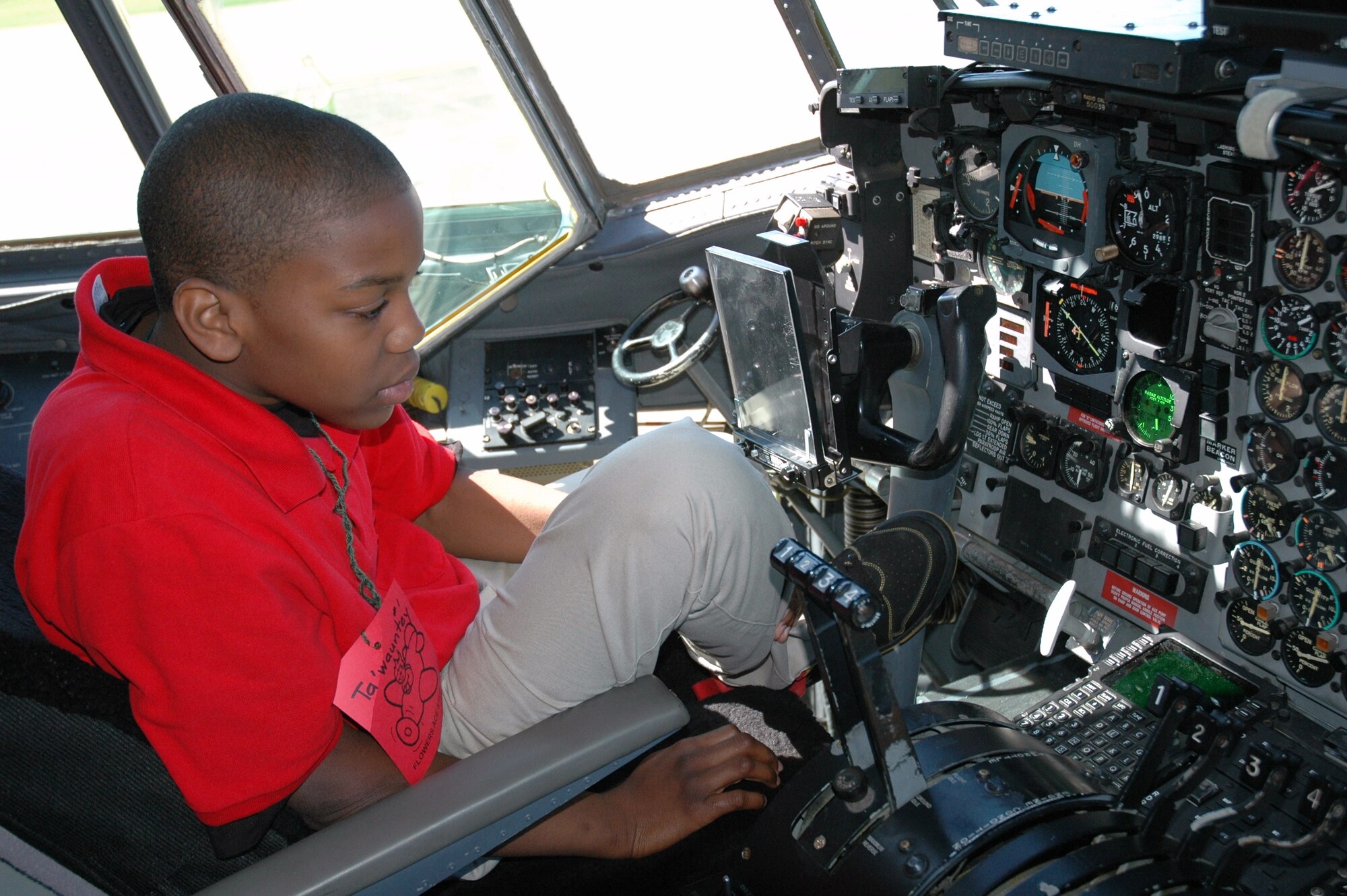 Ta’wauntey Fuller, a student at Flowers Elementary School, checks out the cockpit of a C-130 Hercules during a visit to the 908th Airlift Wing on Aerospace Adventures Day. (Air Force photo/Gene H. Hughes)