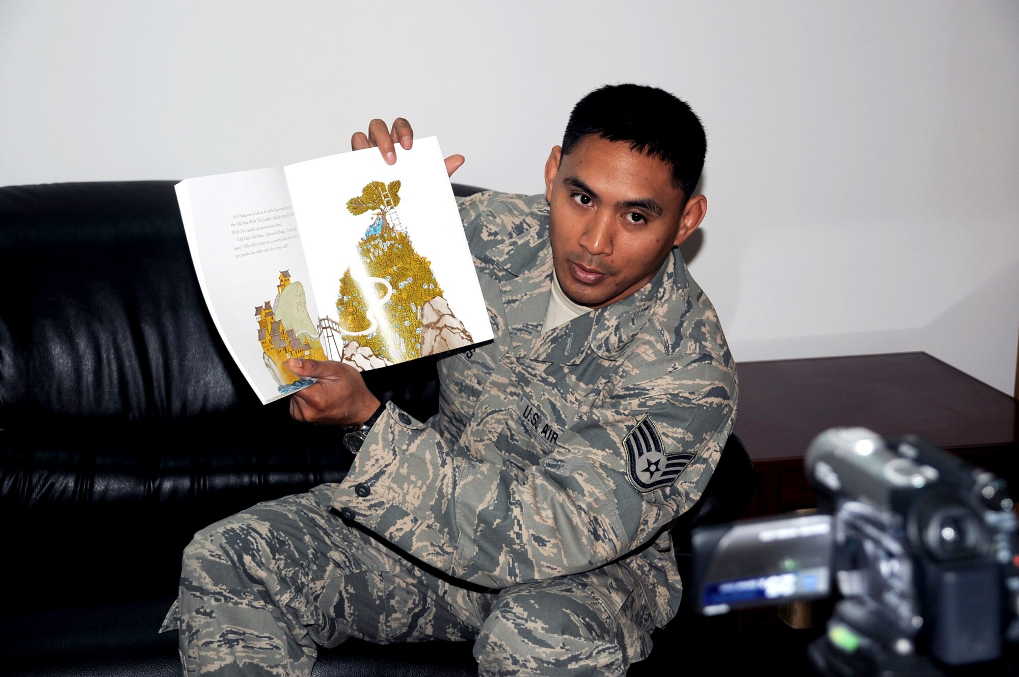 Staff Sgt. Gavin Ramos is video-recorded April 8, 2010, while reading a book for his children at a non-disclosed base in Southwest Asia. Sergeant Ramos was the first Airman at the 380th Air Expeditionary Wing to participate in the USO's United Through Reading program. The program allows a deployed servicemember to read a book while being recorded, and the book and a DVD are sent home to a child to view and follow along. Sergeant Ramos is a services journeyman with the 380th Expeditionary Force Support Squadron. He is deployed from the 154th Force Support Squadron at Joint Base Pearl Harbor-Hickam, Hawaii. (U.S. Air Force Photo/Master Sgt. Scott T. Sturkol)