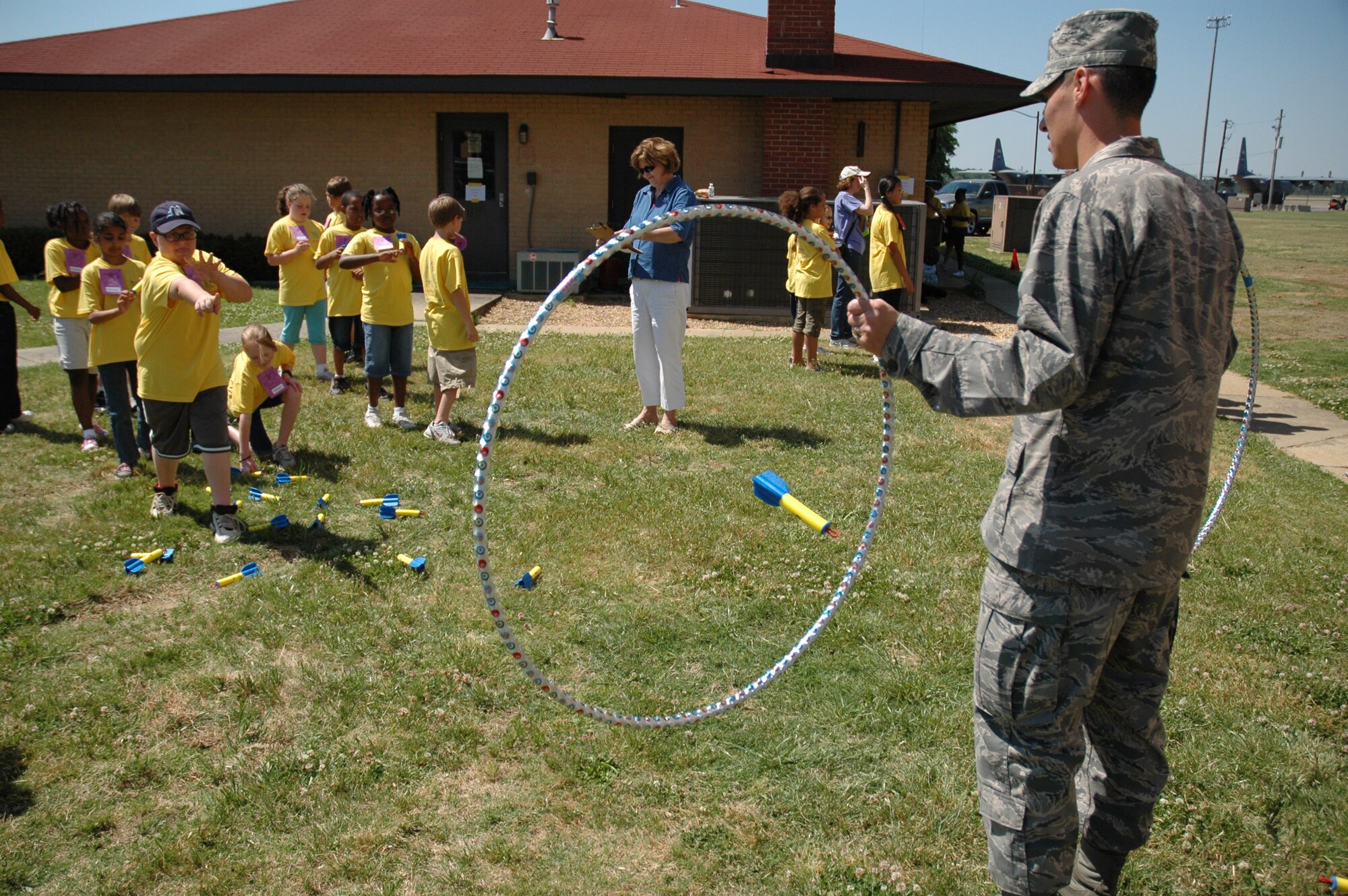 Bear Exploration Center student Mitchell Wilson puts a ‘thumb rocket’ through the center of a target manned by an Officer Training School candidate during Aerospace Adventures Day at Maxwell Air Force Base. (Air Force photo/Gene Hughes)