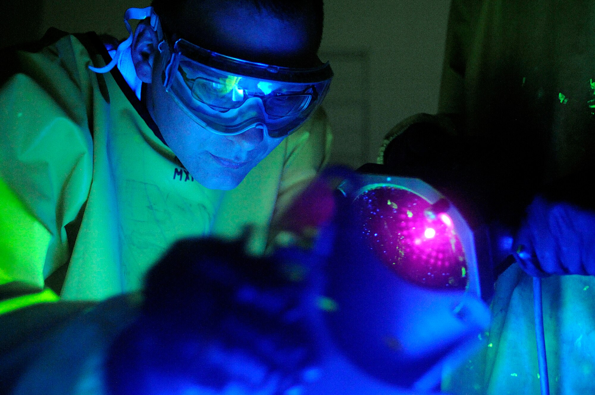 ELLSWORTH AIR FORCE BASE, S.D. – Staff Sgt. Ehud Torres, 28th Maintenance Squadron non-destructive inspection technician, inspects a forward support bracket under ultraviolet light, May 20. Sergeant Torres detects flaws, such as cracks, then interprets the results for the repair center. (U.S. Air Force photo/Airman 1st Class Matthew Flynn)