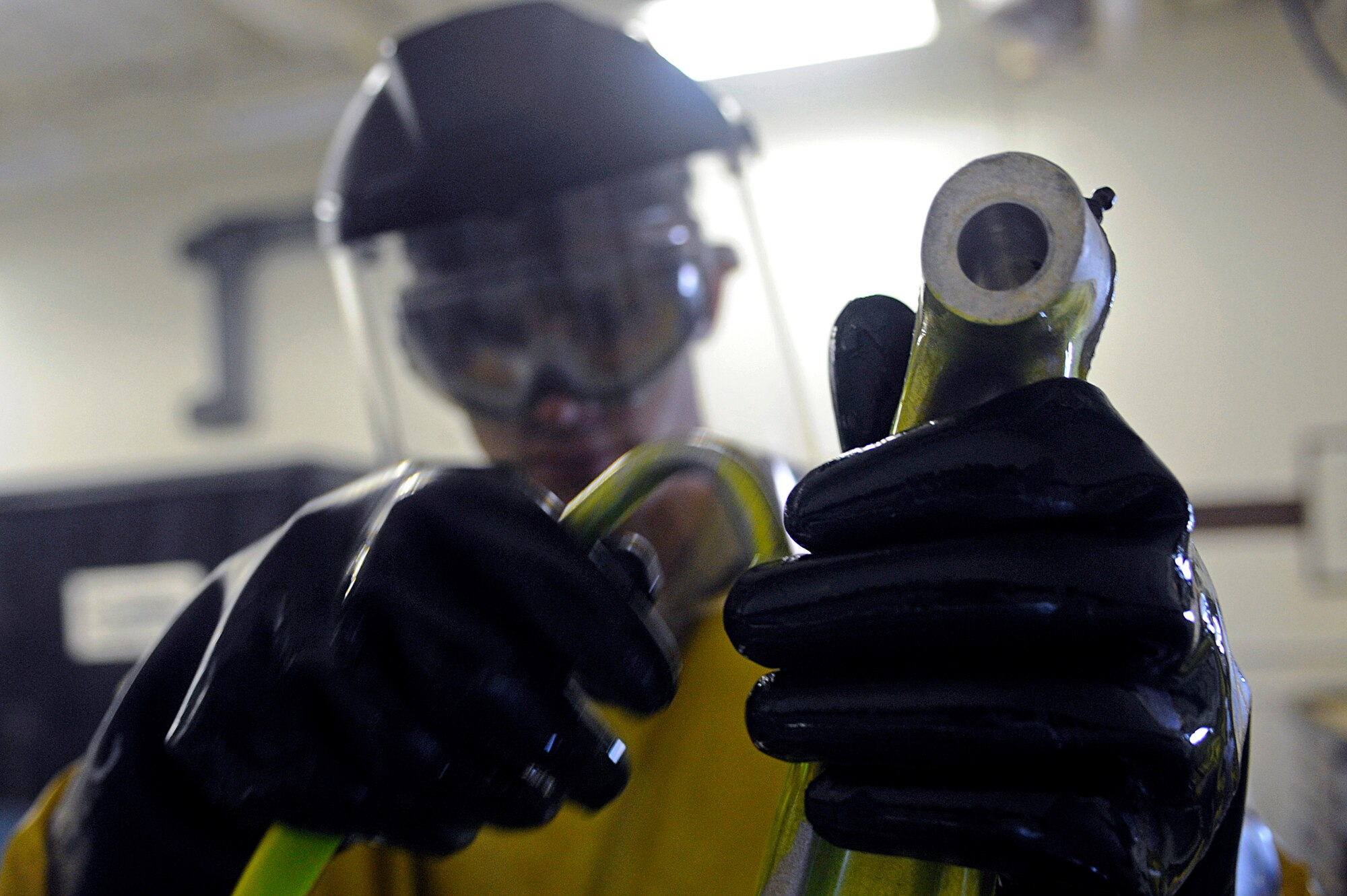 ELLSWORTH AIR FORCE BASE, S.D. – Airman 1st Class Evan Bryant, 28th Maintenance Squadron non-destructive inspection technician, sprays penetrate on the lower links of a jet engine trailer, May 20. The penetrate is designed to seep into possible cracks and make them visible. (U.S. Air Force photo/Airman 1st Class Matthew Flynn)