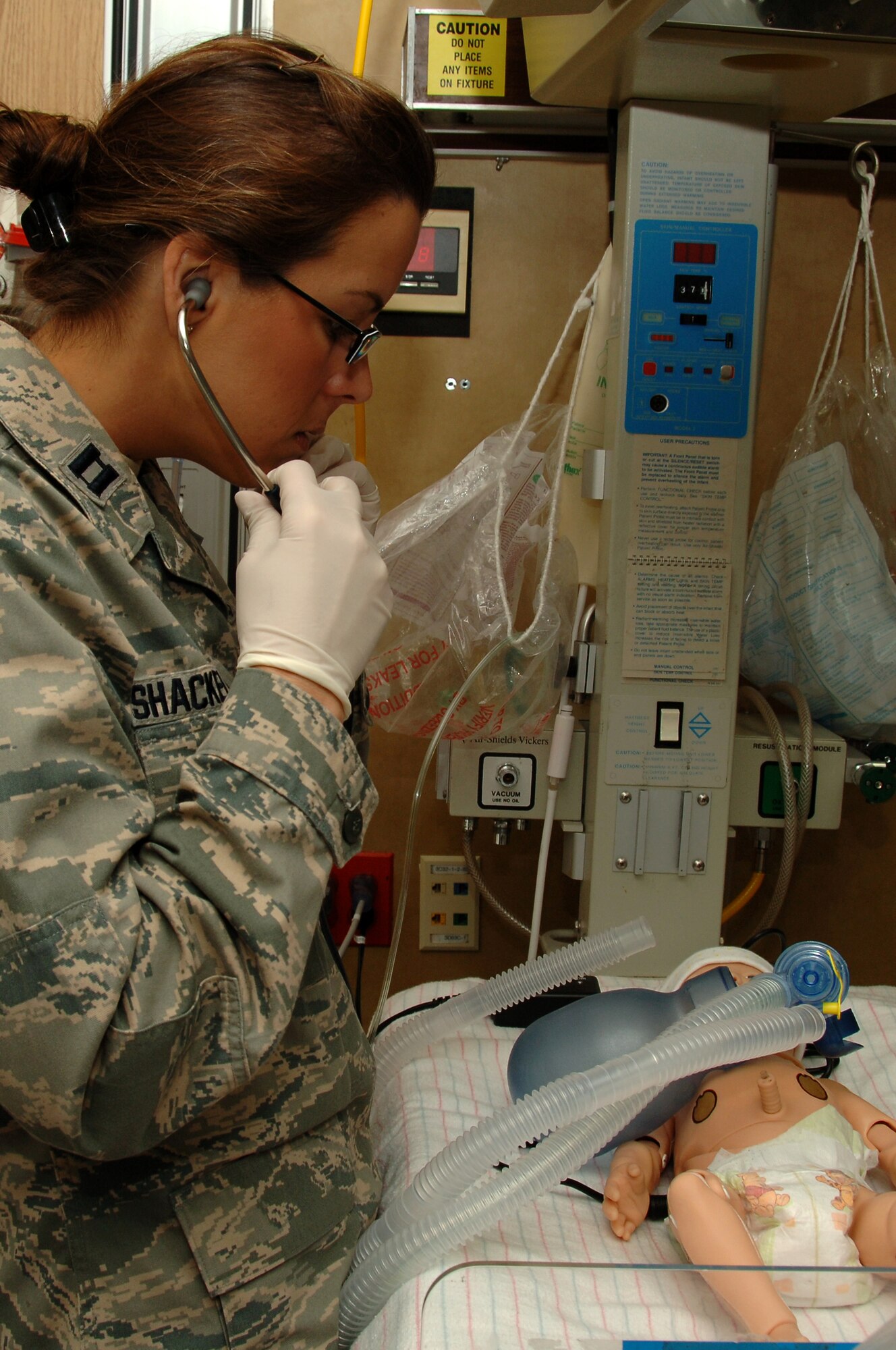 Capt. (Dr.) Brenna Shackelford, emergency medicine resident, 59th Emergency Medicine Squadron, checks the vital signs of a newborn as part of a scenario during simulation grand rounds May 21 in the Wilford Hall Medical Center simulation center, Lackland Air Force Base, Texas. The simulation grand rounds is held every few months and used to augment and improve resident education. (U.S. Air Force photo by Senior Airman Nicole Mickle)