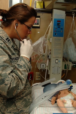 Capt. (Dr.) Brenna Shackelford, emergency medicine resident, 59th Emergency Medicine Squadron, checks the vital signs of a newborn as part of a scenario during simulation grand rounds May 21 in the Wilford Hall Medical Center simulation center, Lackland Air Force Base, Texas. The simulation grand rounds is held every few months and used to augment and improve resident education. (U.S. Air Force photo by Senior Airman Nicole Mickle)