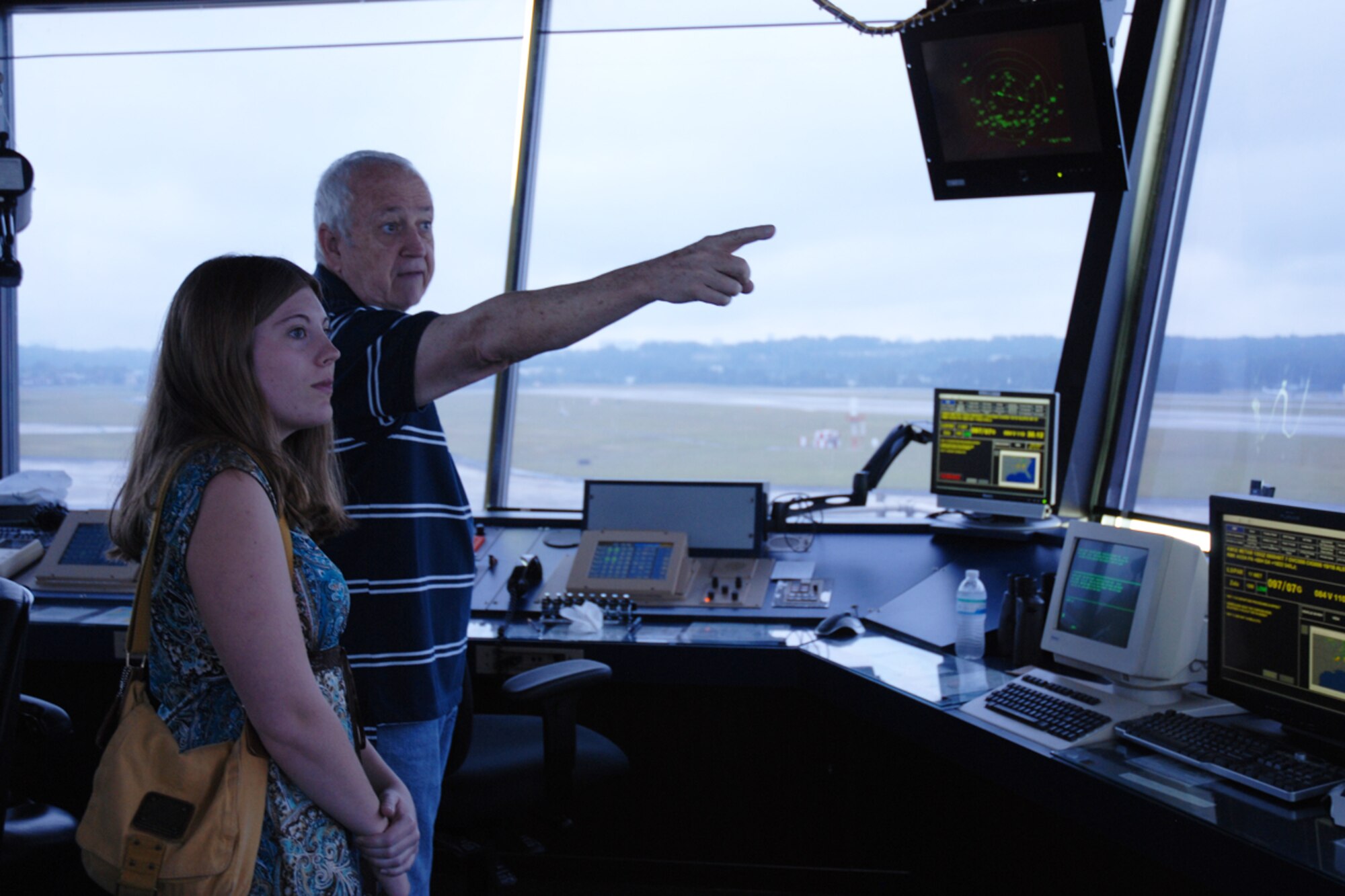 James E. Ireland, air traffic controller, 94th Airlift Wing, gives Morgan Turner, Newnan High School JROTC cadet, an overview of daily operations in the Dobbins Air Traffic Control Tower during a base visit May 21. Turner plans to join the U.S. Air Force upon graduation and become an air traffic controller. She will receive a letter of recommendation from Lt. Col. Glenn Broadnax, senior aerospace science instructor, Newnan High School, guaranteeing her a position in the career field. (U.S. Air Force photo/Tech. Sgt. James Branch)