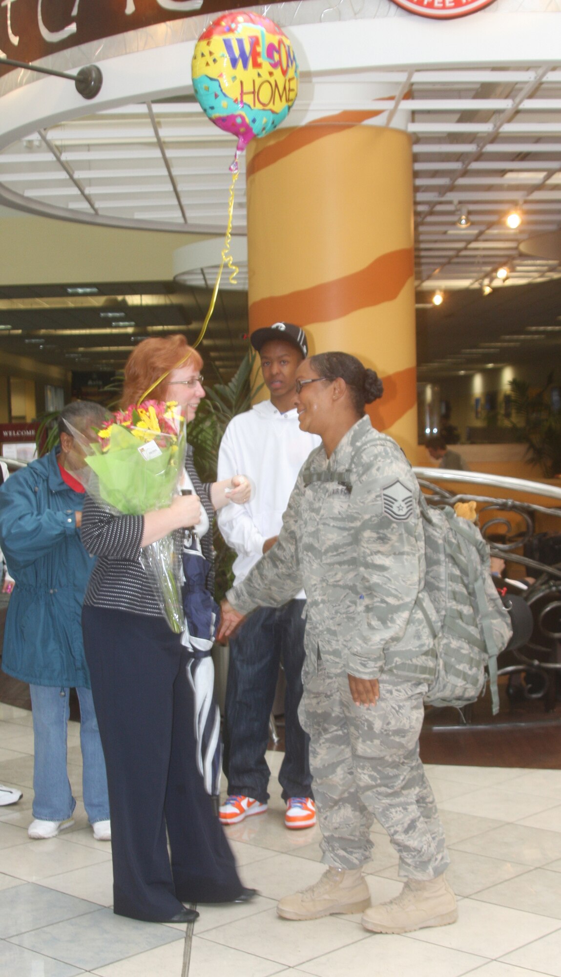 WRIGHT-PATTERSON AIR FORCE BASE, Ohio – Master Sgt. Leegurtha Lucas, 445th Mission Support Flight, is greeted by family and friends at the Dayton International Airport May 17 after returning from a 120-day deployment to Bagram Air Base, Afghanistan. Sergeant Lucas was assigned to the 755th Air Expeditionary Group where she was a knowledge operations manager assigned as the non-commissioned officer in charge of the knowledge management section.  (U.S. Air Force photo/Stacy Vaughn)