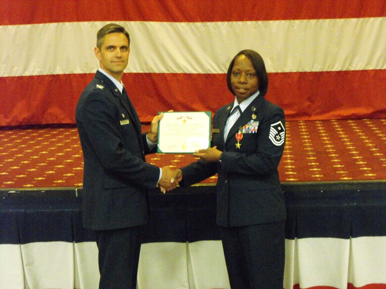 BARKSDALE AIR FORCE BASE, La. – Col. Steven L. Basham, 2d Bomb Wing commander, presents Master Sgt. Keisha Yarbrough the Bronze Star for her oustanding performance as a "Sergeant of the Guard" while deployed to Camp Bucca, Iraq, from 2007 to 2008. Sergeant Yarbrough was recently honored as the 2009 Air Force Global Strike Command First Sergeant and Outstanding Airman of the Year.  (Courtesy Photo)