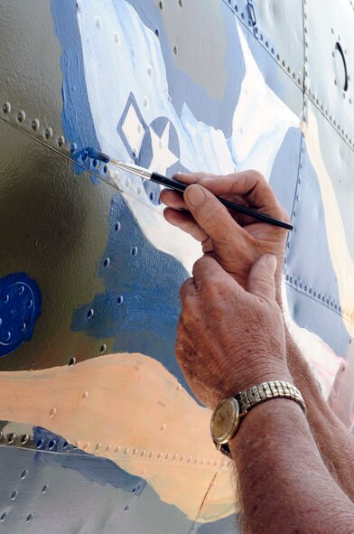 BARKSDALE AIR FORCE BASE, La. -- Ron Fountain, Houston’s Southwest Museum Services development director, carefully paints "Miss Liberty" on the nose of a B-17G at the Eighth Air Force museum May 19. The near-complete paint job mirrors a B-17G that was flown by Maj. Gen. Lewis E. Lyle, who flew many missions in B-17s during World War II. (U.S. Air Force photo/Staff Sgt. John Gordinier)