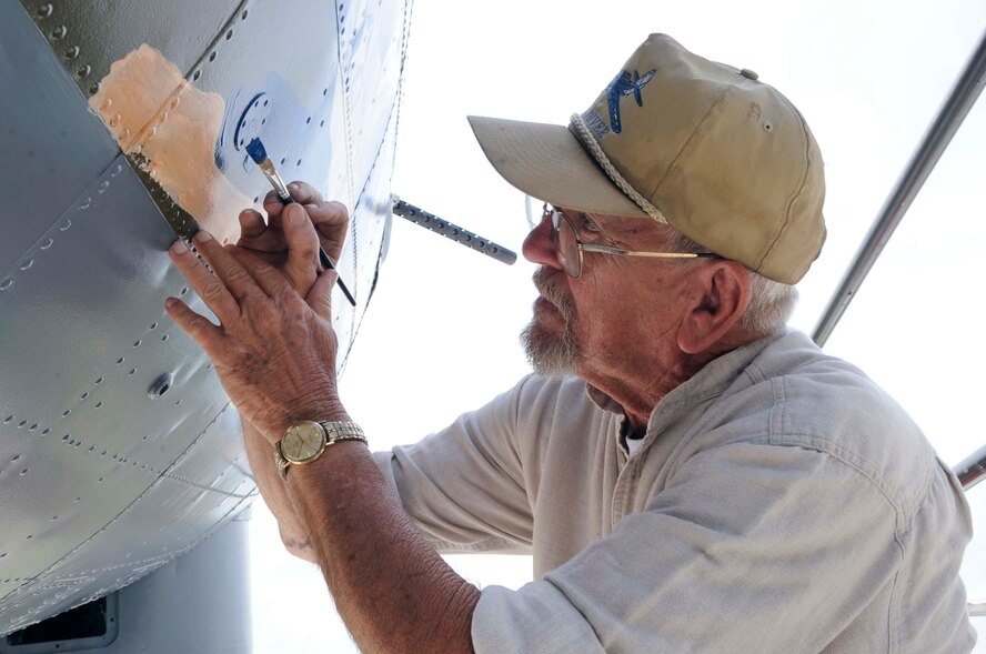 BARKSDALE AIR FORCE BASE, La. -- Ron Fountain, Houston’s Southwest Museum Services development director, carefully paints "Miss Liberty" on the nose of a B-17G at the Eighth Air Force museum May 19. The near-complete paint job mirrors a B-17G that was flown by Maj. Gen. Lewis E. Lyle, who flew many missions in B-17s during World War II. (U.S. Air Force photo/Staff Sgt. John Gordinier)